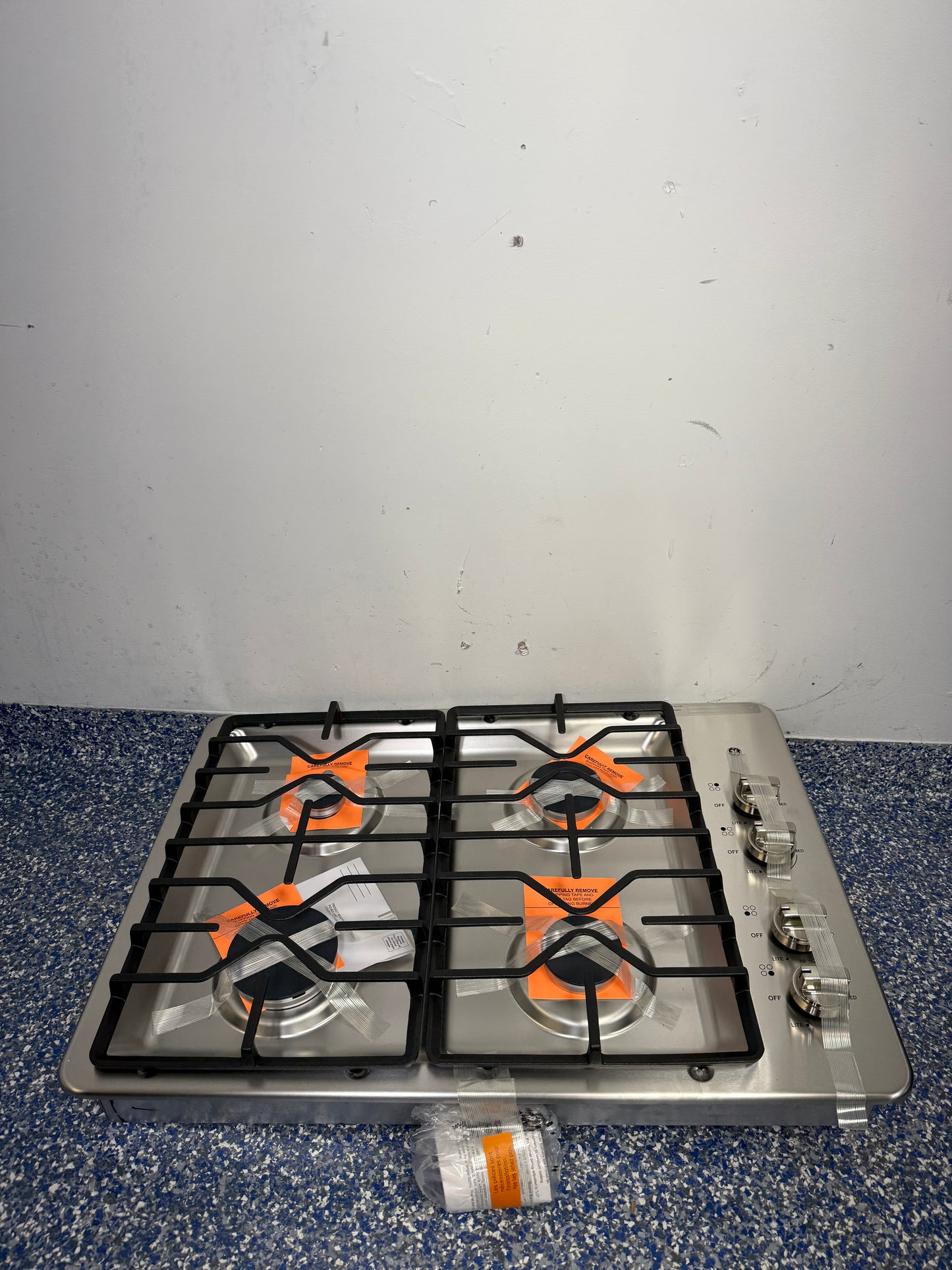 Stainless Steel GE Built-In Gas Cooktop with Side Knobs and Deep-Recessed Cooktop at Appliance Shark in Overland Park, Kansas