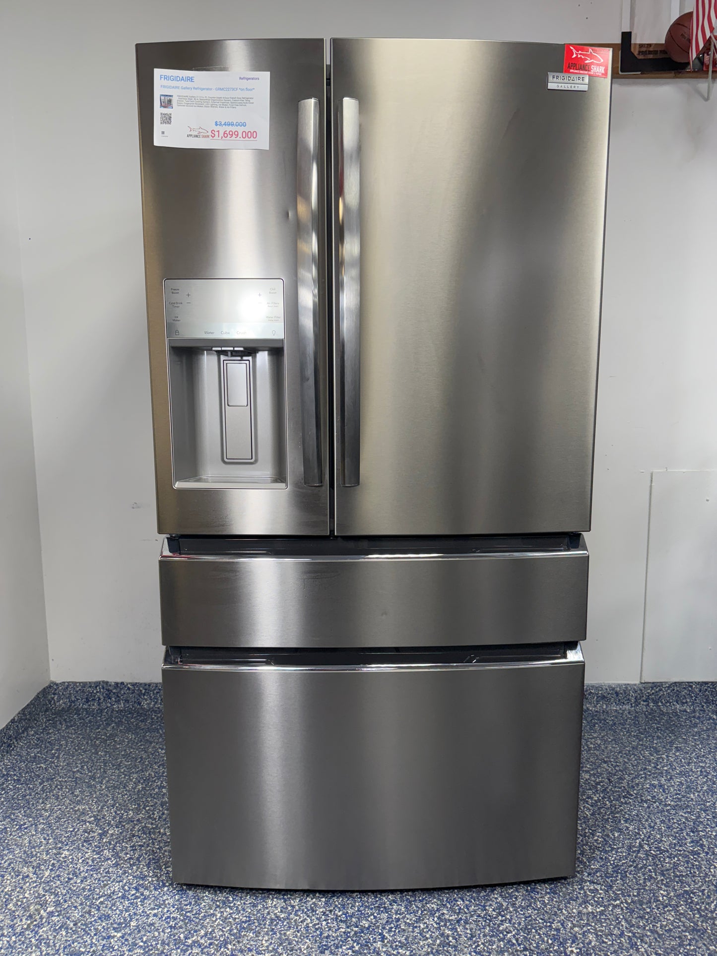 A full frontal image of the FRIGIDAIRE GRMC2273CF French door refrigerator, highlighting its Smudge-Proof® Stainless Steel finish and external dispenser. On sale at Appliance Shark - Scratch & Dent store | Kansas City.