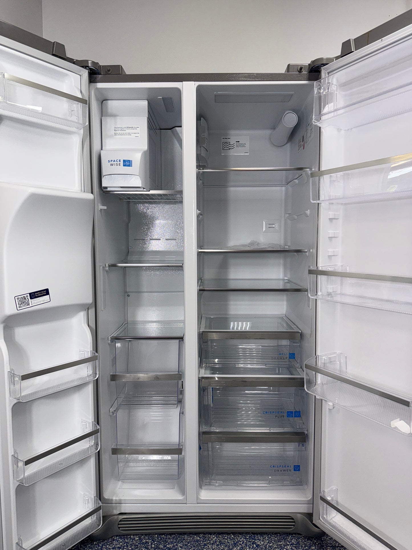 A close-up view of the filtered water and ice dispenser on the FRIGIDAIRE GRSC2352AF, for sale in Kansas.