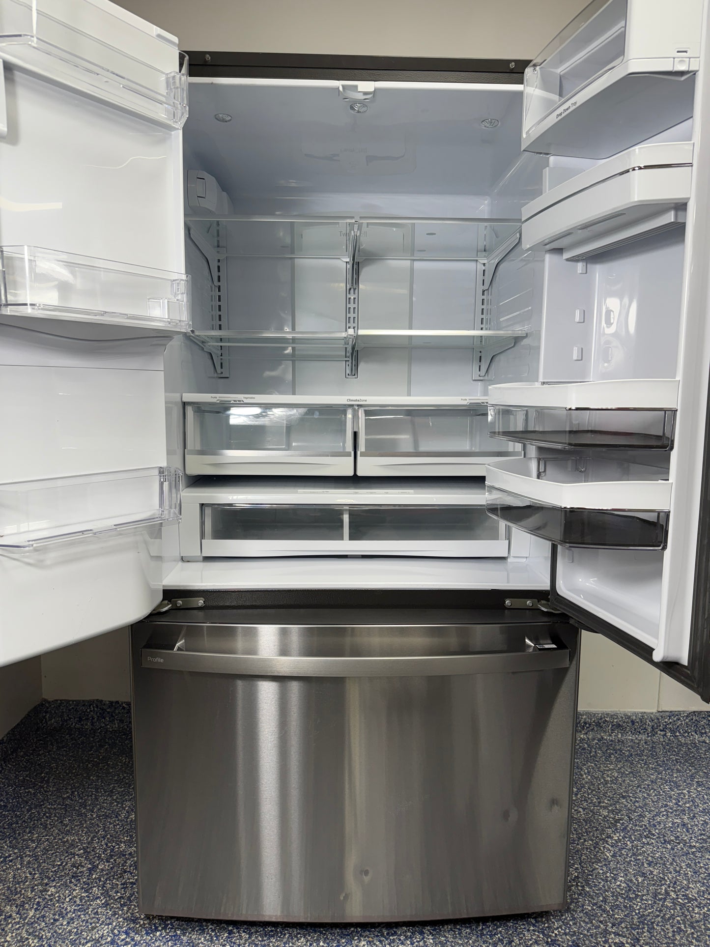 Interior view of the main refrigerator compartment of the GE Profile PFE28KYNFS, highlighting the full-width temperature-controlled drawer. On sale at Appliance Shark - Scratch & Dent store | Kansas City.