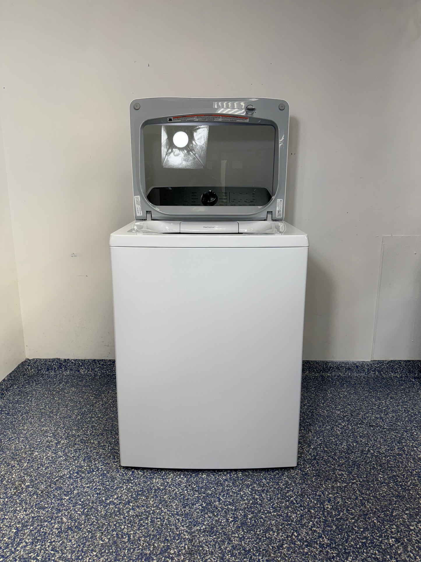 An overhead shot of the GE PTW600BSRWS with the lid open, revealing the spacious stainless steel wash basket and Impeller. On sale at Appliance Shark - Scratch & Dent store | Kansas City.
