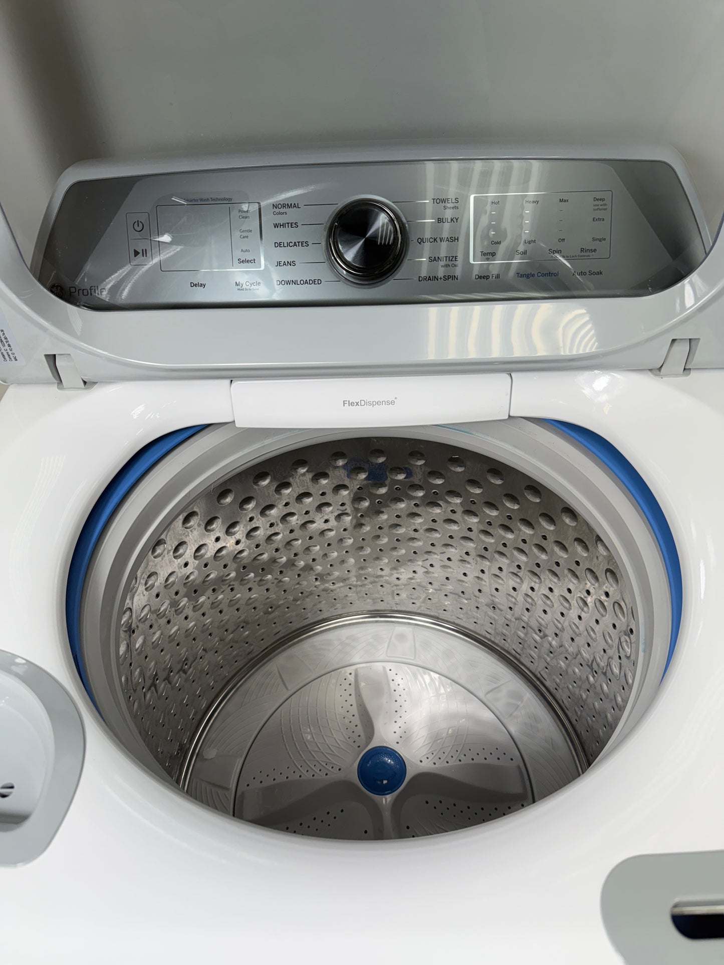 A close-up of the stainless steel wash drum interior of the PTW600BSRWS washer, featuring Microban® Antimicrobial Technology. On sale at Appliance Shark - Scratch & Dent store | Kansas City.