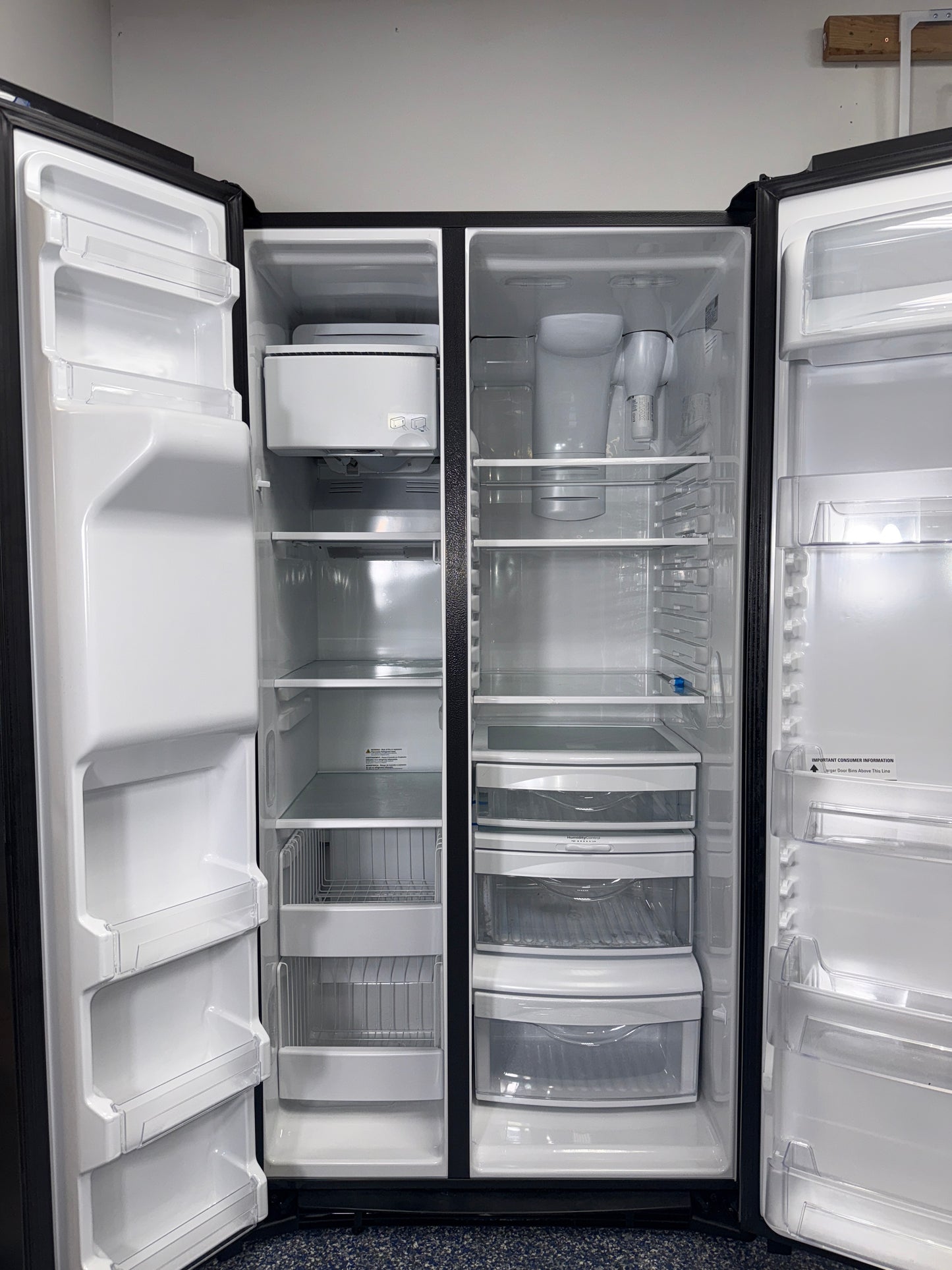 A close-up view of the external ice and water dispenser on the GE refrigerator, model GSS25IYNFS, an ideal appliance for homes in Overland Park.