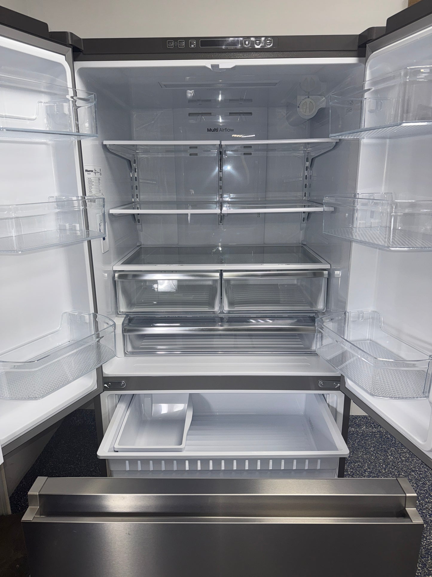 Interior view of the HISENSE HRF266N6CSE1 refrigerator showing adjustable glass shelves and wide storage for Overland Park, KS homes.