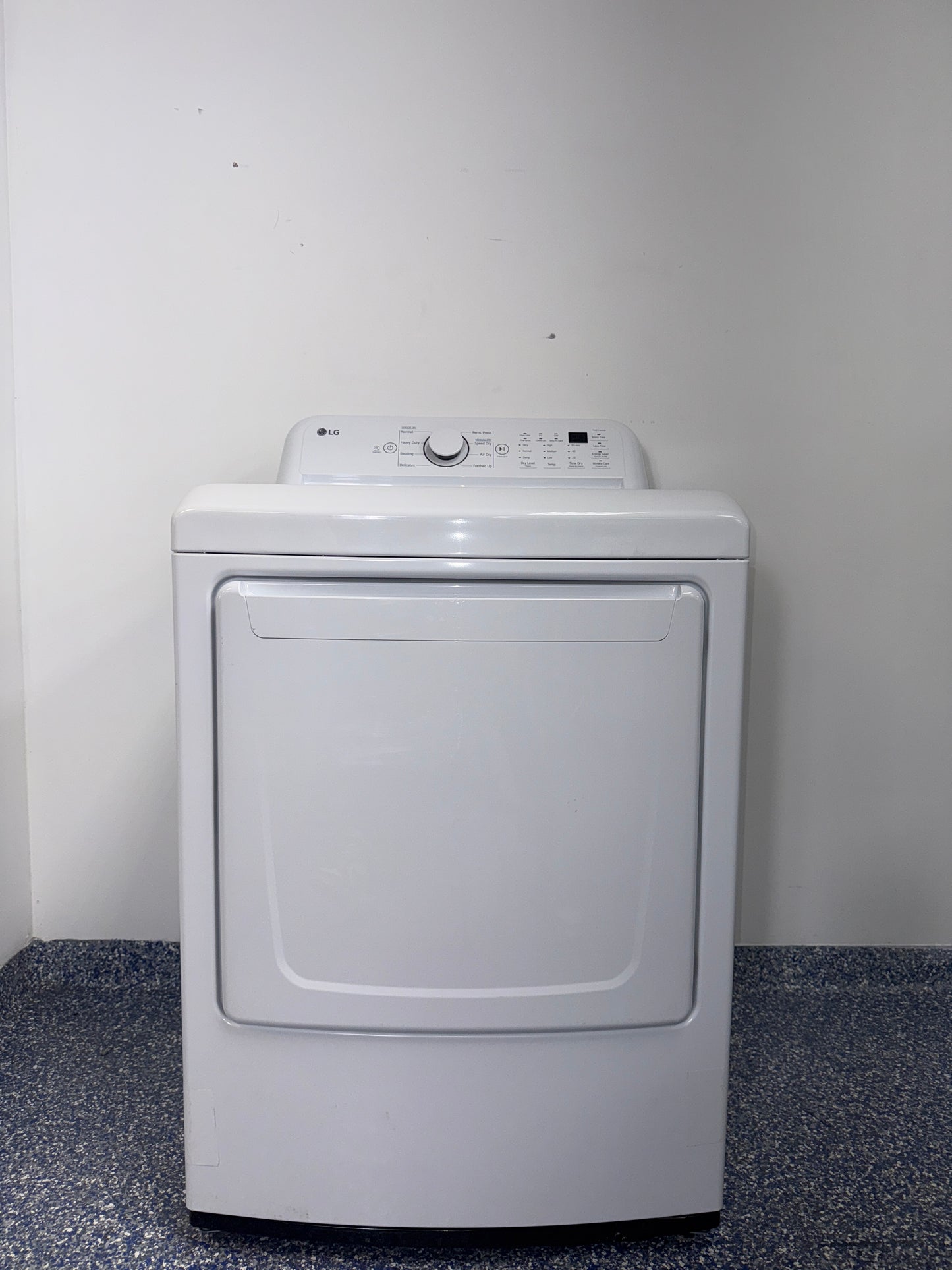 A front view of the LG DLE7000W dryer, highlighting its durable Aluminized Alloy Steel Drum, ready for installation in a Kansas City laundry room.
