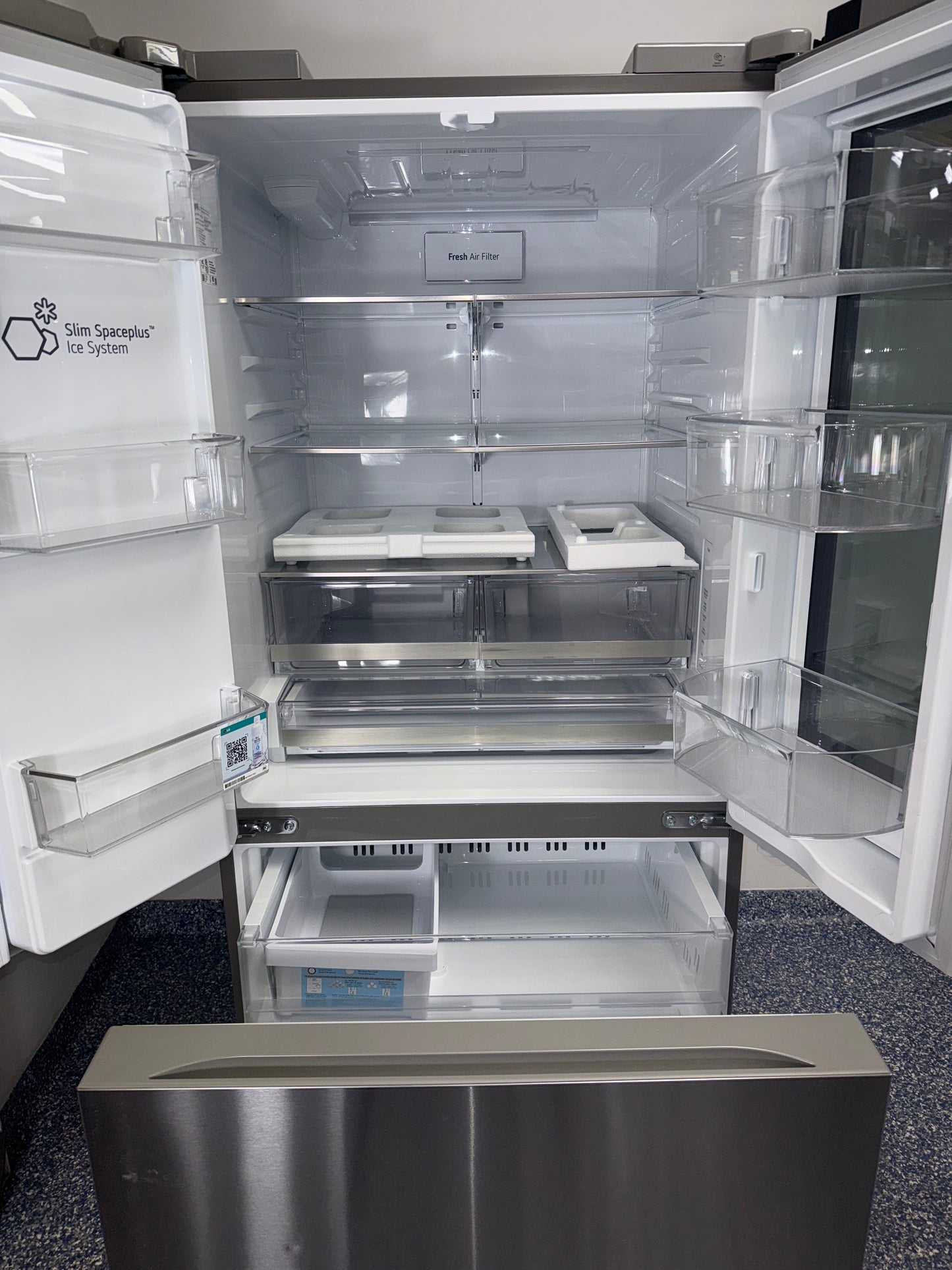 Front view of the LG LF25S6560S 3-door French-door refrigerator in a Kansas City kitchen setting.