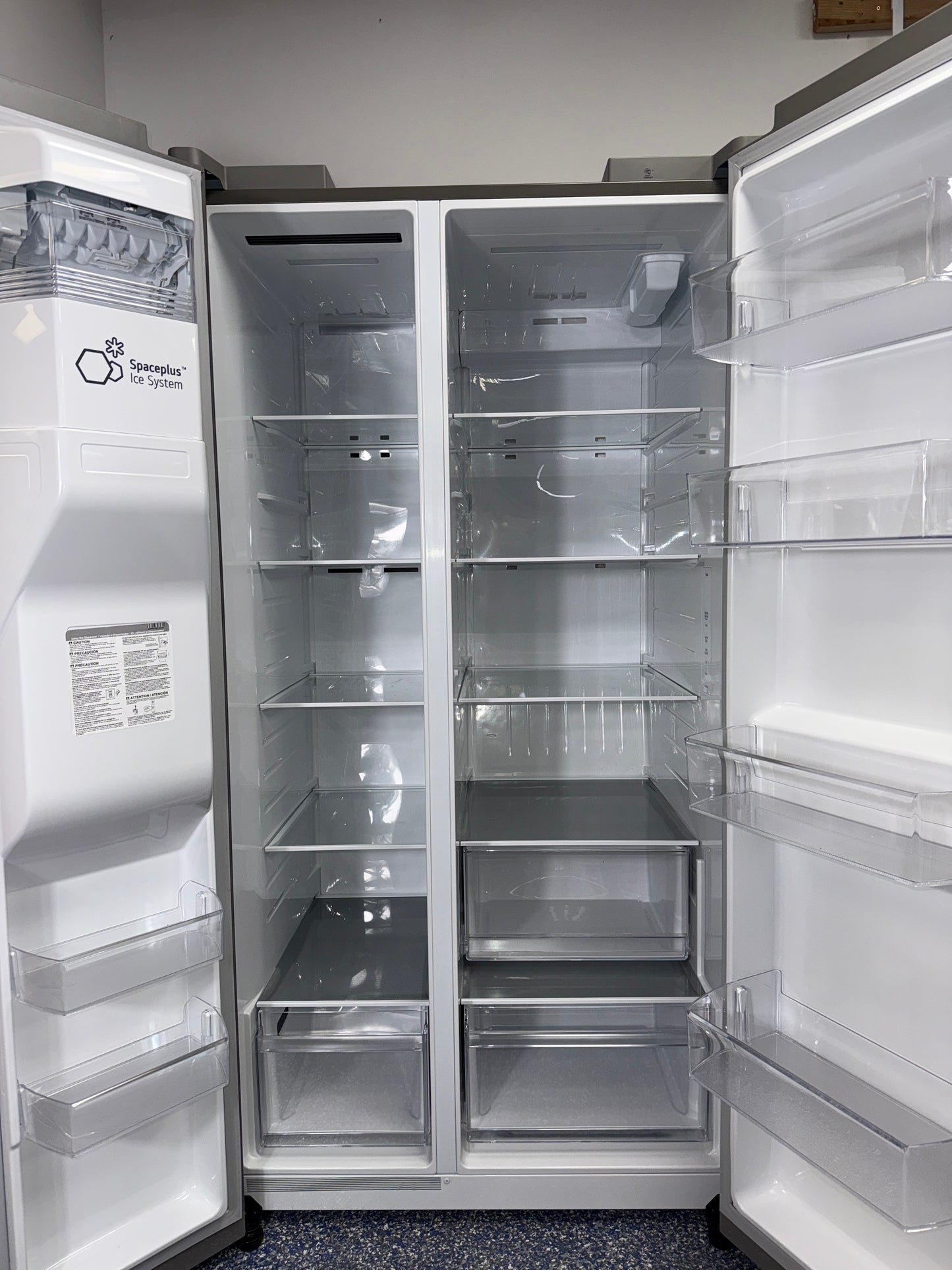 A close-up view of the exterior ice and water dispenser on the LG LS27T3230S, for sale in Kansas.