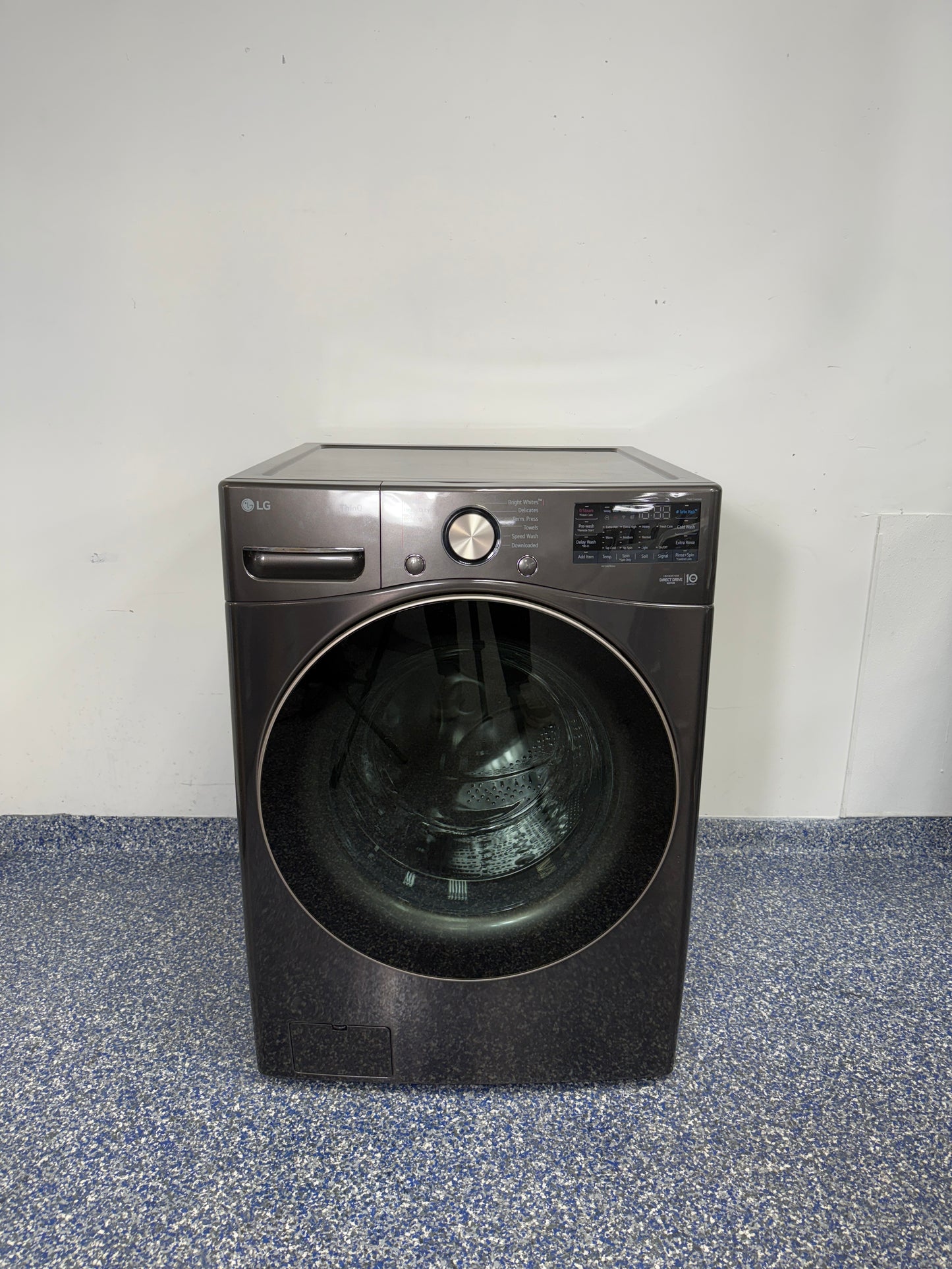 A full frontal image of the LG WM4000HBA smart washing machine, showcasing its Black Steel finish and AI-enabled control panel. On sale at Appliance Shark - Scratch & Dent store | Kansas City.