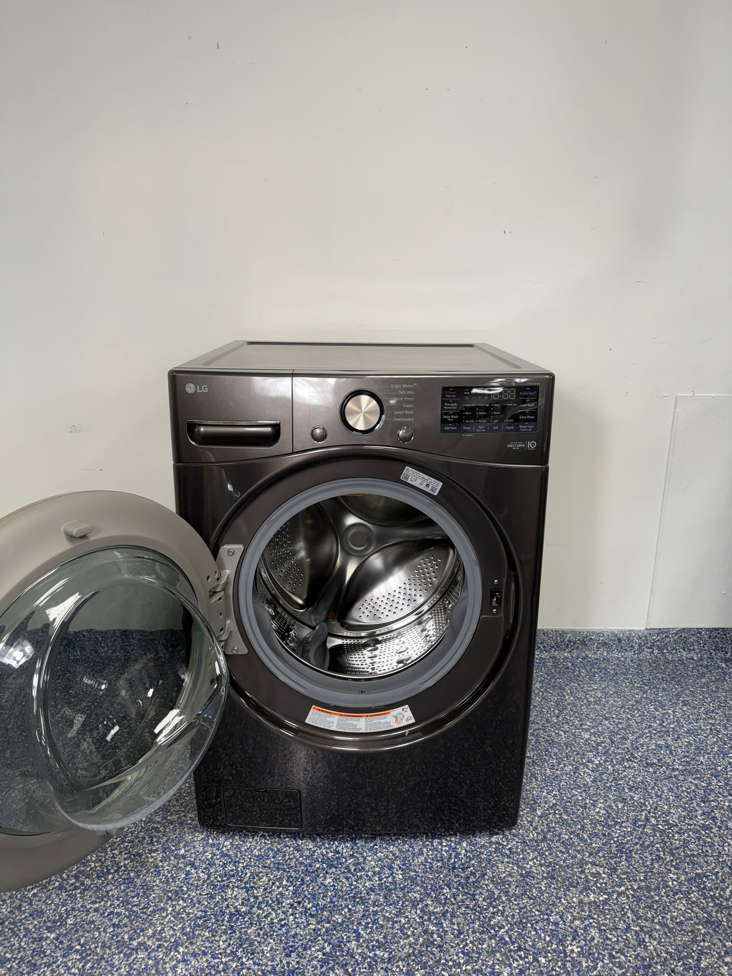 An overhead shot of the LG WM4000HBA with the door open, revealing the large stainless steel drum and Ultra Large Capacity. On sale at Appliance Shark - Scratch & Dent store | Kansas City.