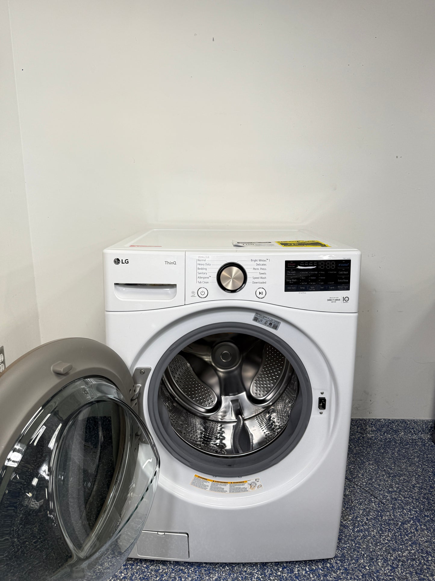 An overhead shot of the LG WM4000HWA with the door open, revealing the large stainless steel drum and ultra-large capacity. On sale at Appliance Shark - Scratch & Dent store | Kansas City.