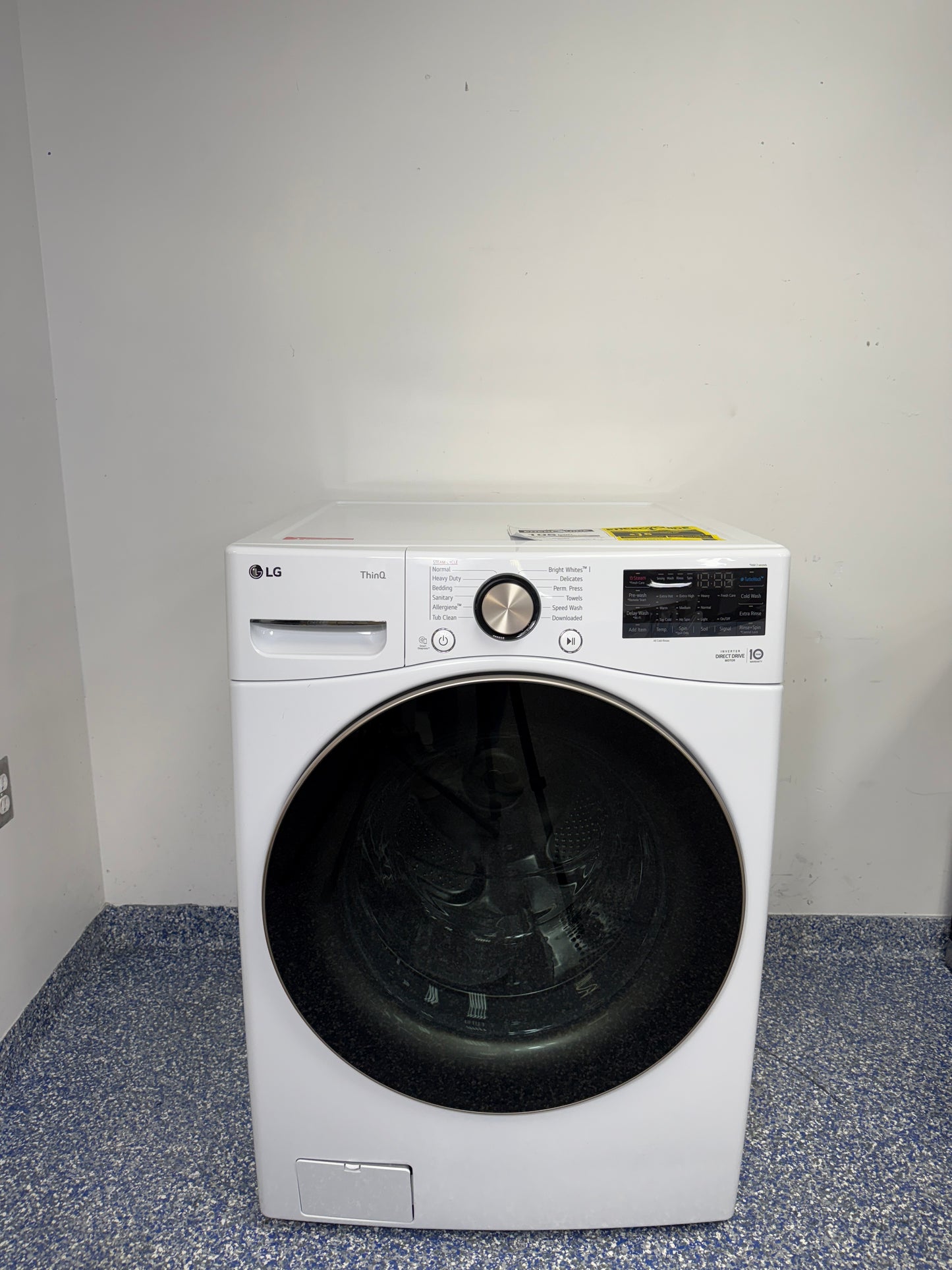 A full frontal image of the LG WM4000HWA front-load stackable washing machine, highlighting its clean white finish and digital control panel. On sale at Appliance Shark - Scratch & Dent store | Kansas City.