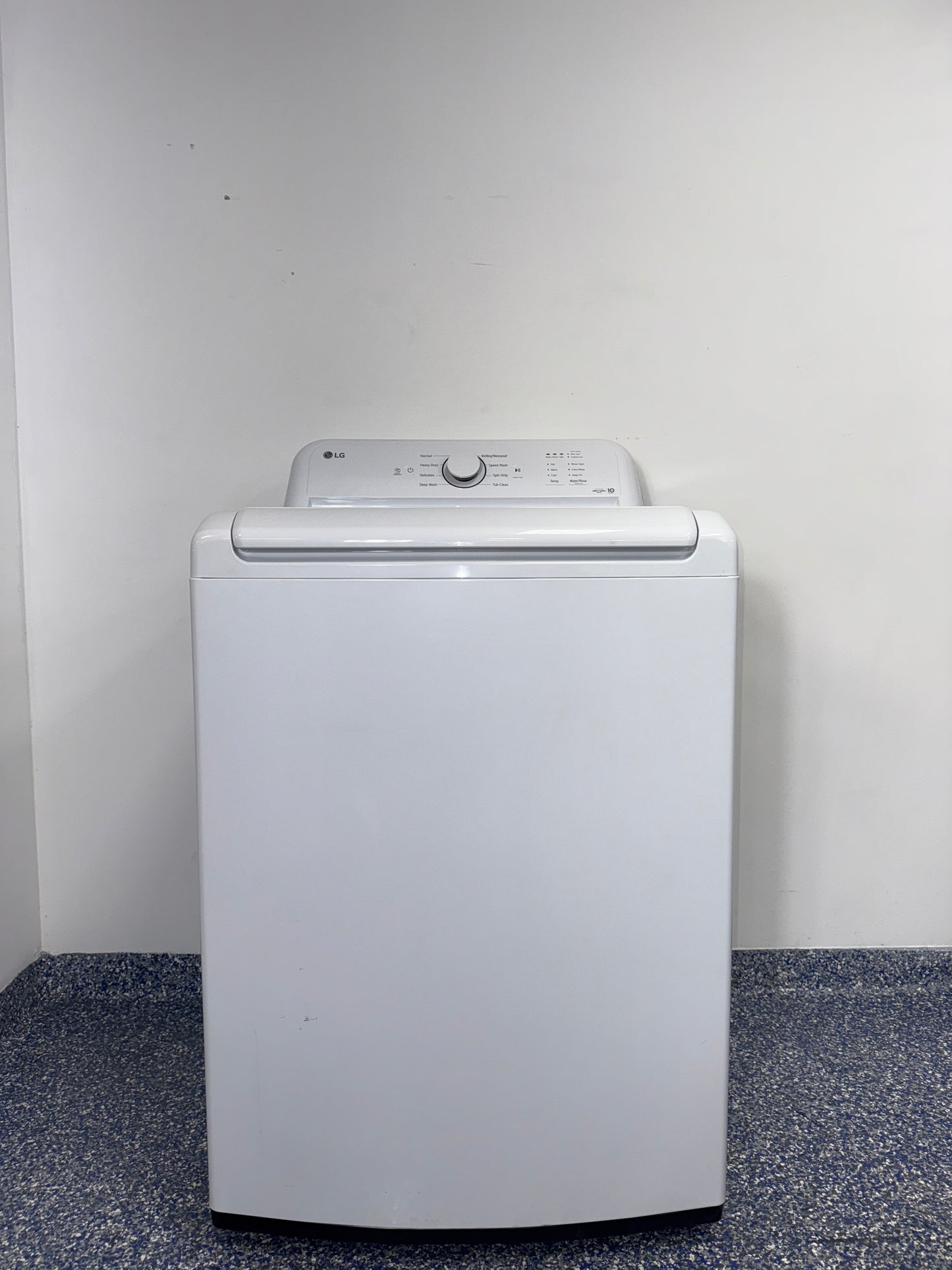 The interior of the LG WT6105CW washer, showcasing its durable stainless steel drum, for sale in Kansas.