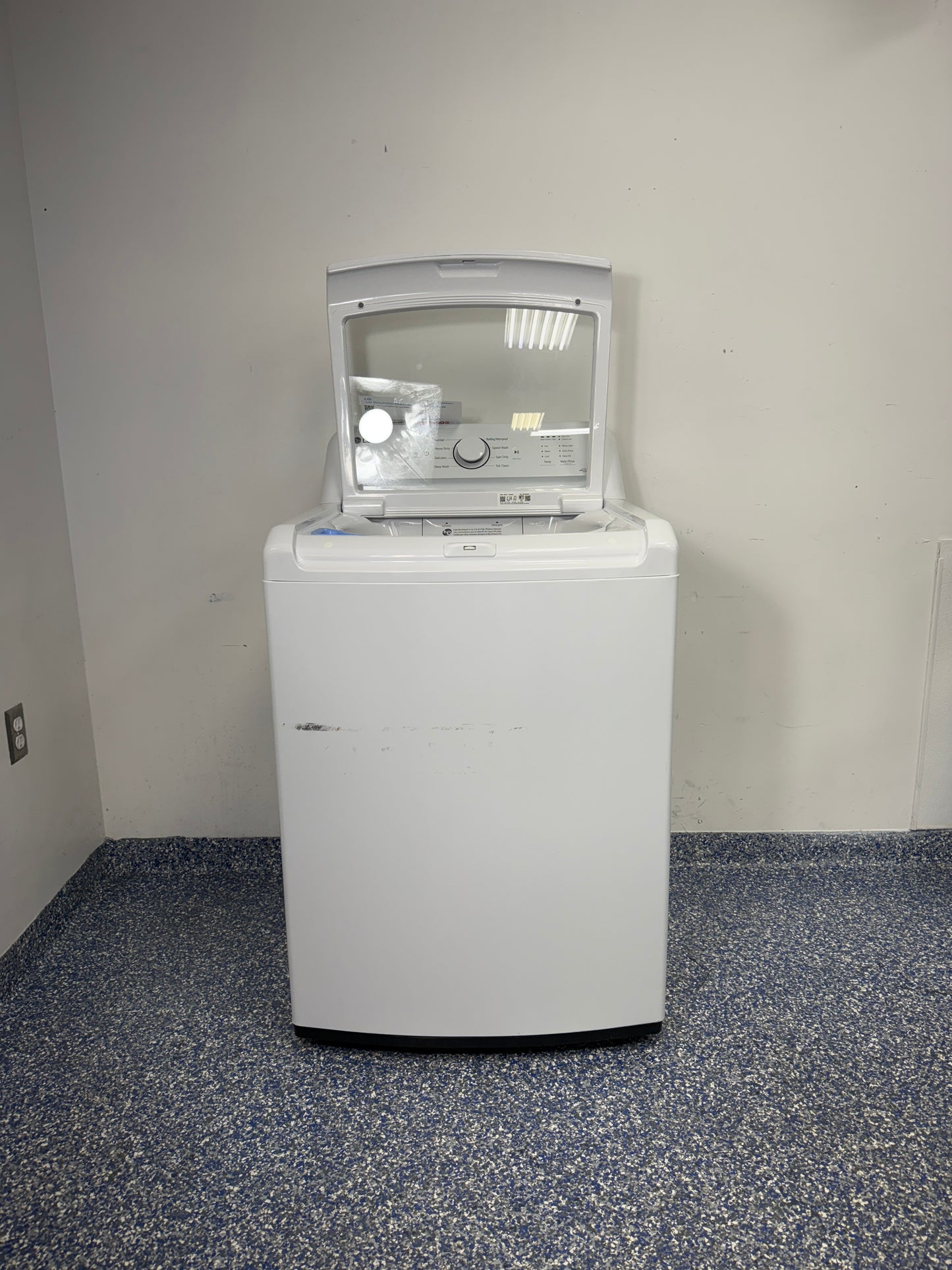 An overhead shot of the LG WT6105CW with the lid open, showcasing the large stainless steel drum and 4-Way Agitator. On sale at Appliance Shark - Scratch & Dent store | Kansas City.