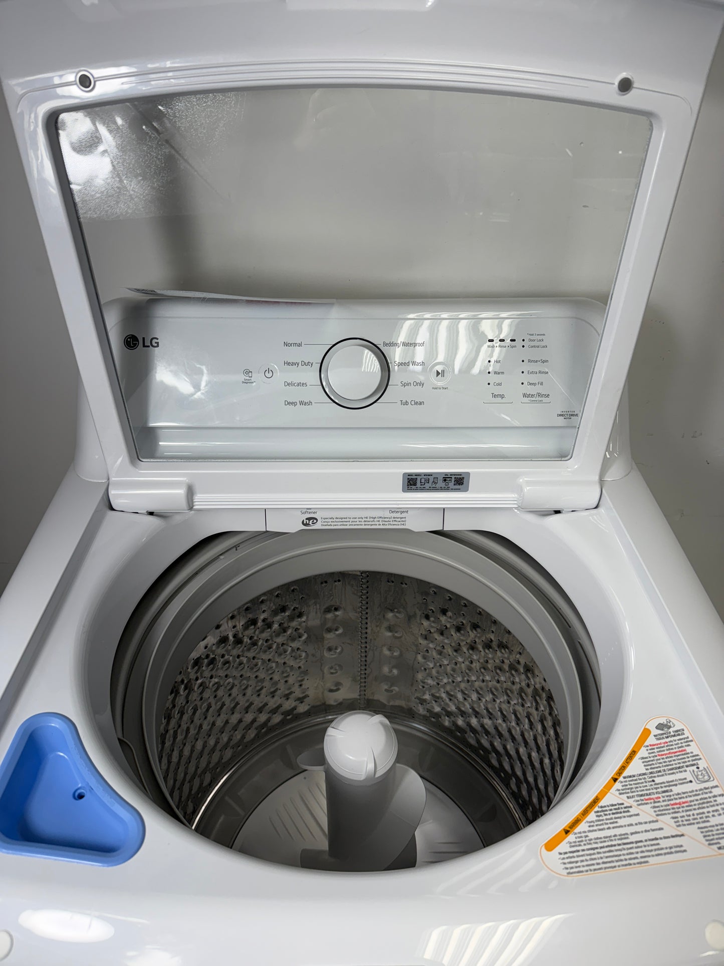 A close-up view of the stainless steel drum interior of the WT6105CW washer, featuring the 4-Way Agitator and TurboDrumâ„¢ Technology. On sale at Appliance Shark - Scratch & Dent store | Kansas City.