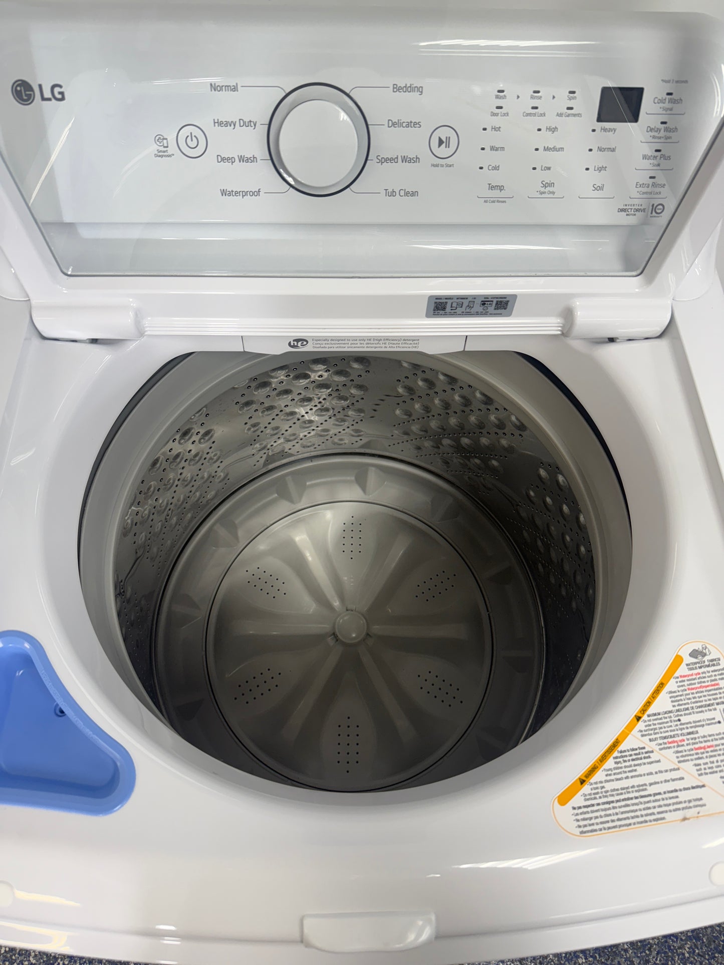 A front view of the LG WT7000CW washer, highlighting its simple, durable design, ready for installation in a Kansas City laundry room.