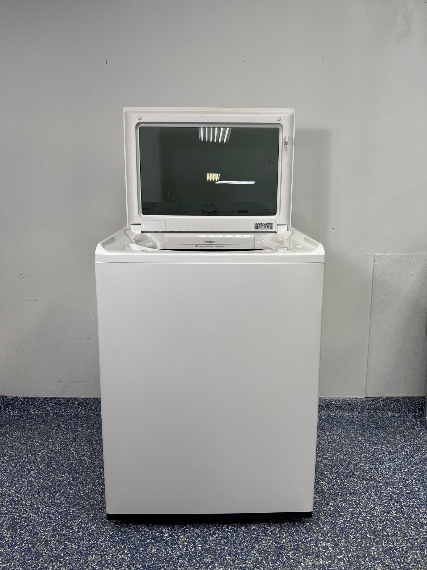 Top view of the LG WT8200CW washer with its lid open, showing the large stainless steel drum and mega capacity. On sale at Appliance Shark - Scratch & Dent store | Kansas City.