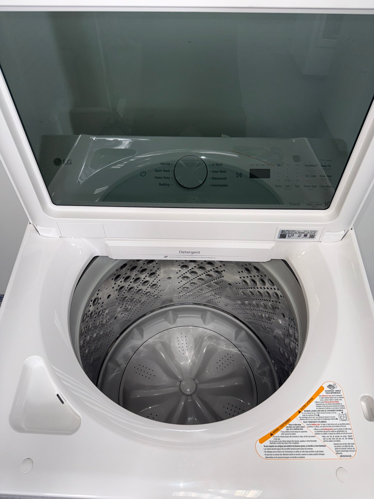 A close-up view of the agitatorless interior of the LG WT8200CW washer, highlighting the TurboDrum™ technology. On sale at Appliance Shark - Scratch & Dent store | Kansas City.