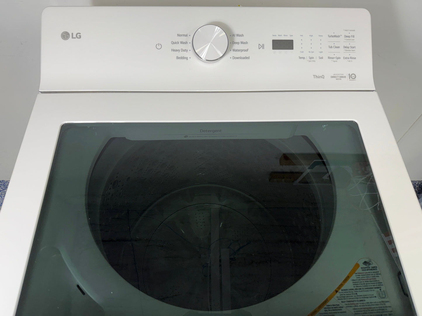 The interior of the LG WT8205CW washer, showing the NeveRustâ„¢ stainless steel drum and ColdWashâ„¢ technology, for sale in Kansas.