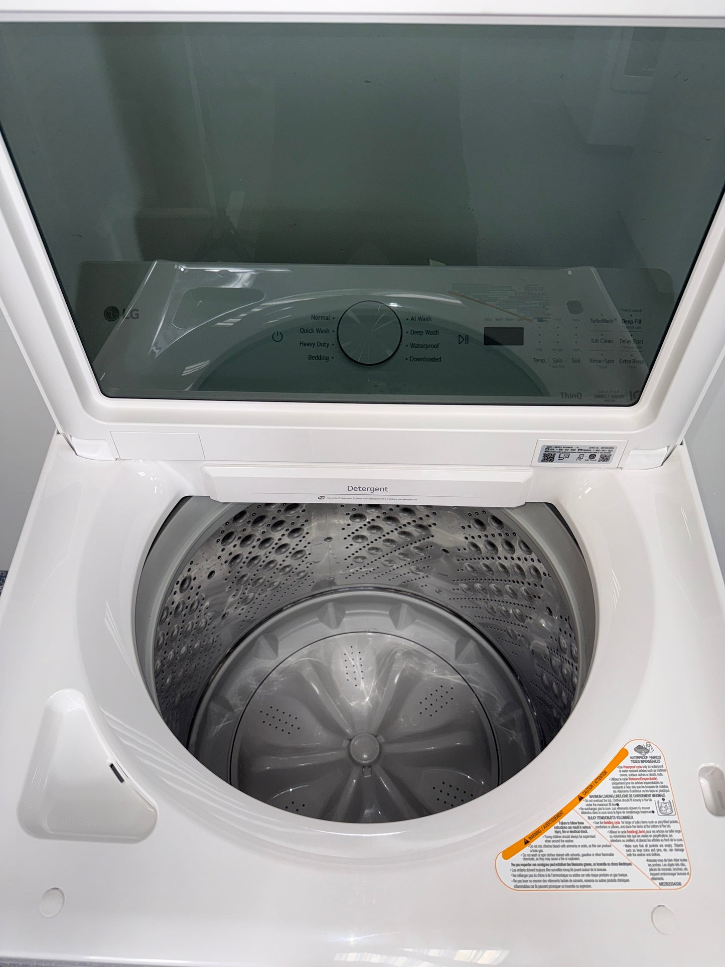 A front view of the LG WT8205CW washer, highlighting its durable stainless steel drum, ready for installation in a Kansas City laundry room.