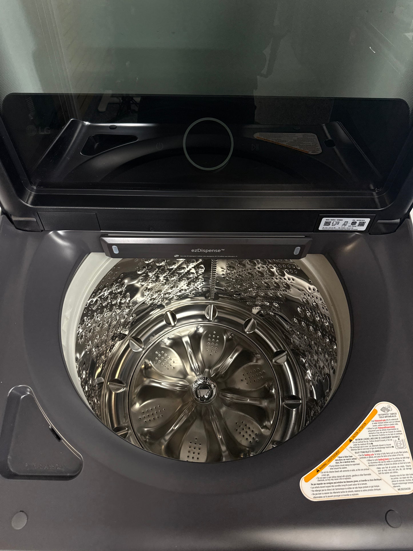 A front view of the LG WT8600CB washer, highlighting its built-in water faucet, ready for installation in a Kansas City laundry room.