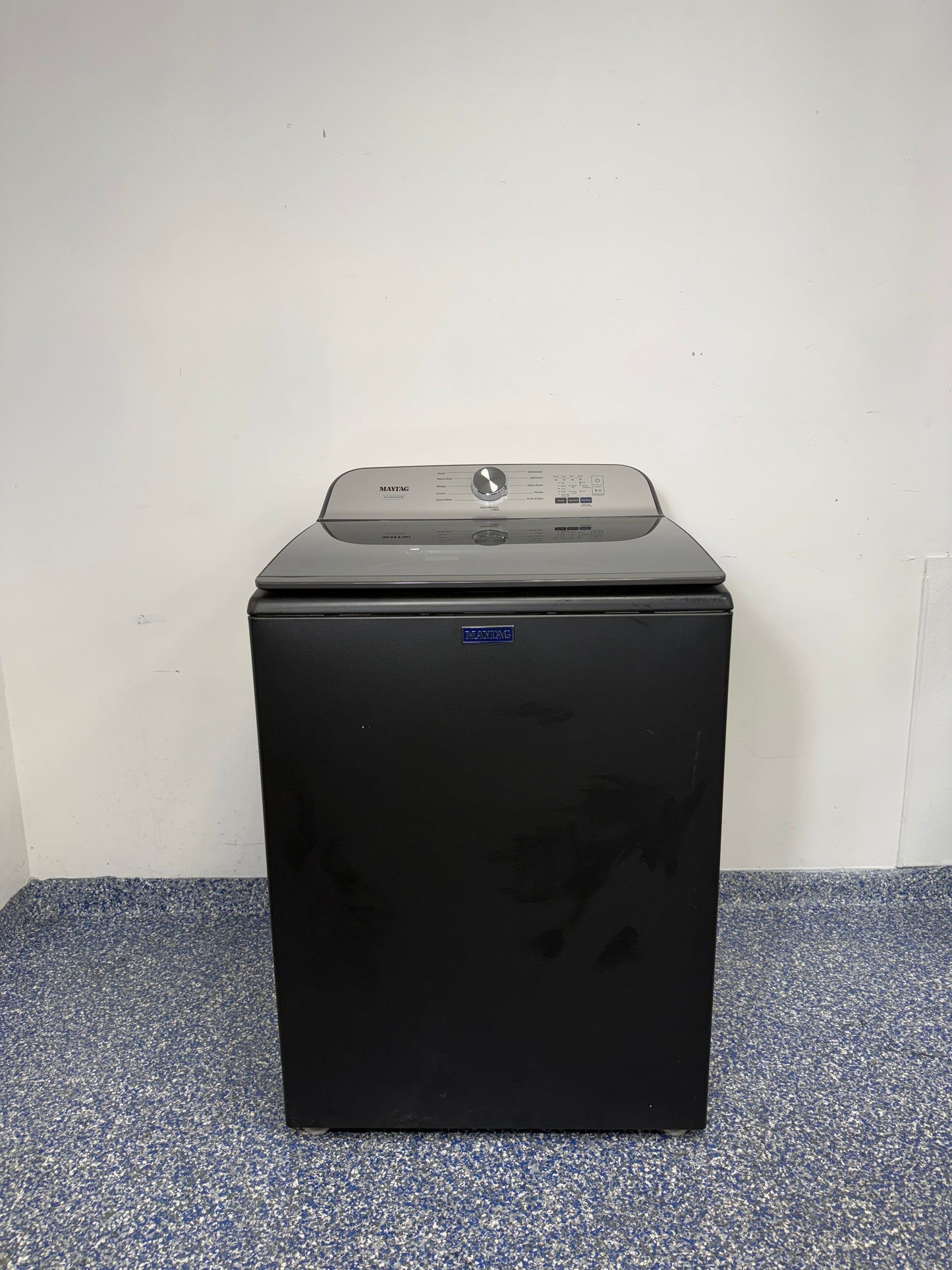 A full frontal image of the MAYTAG MVW6500MBK Top Load Pet Pro Washing Machine, highlighting its Volcano Black finish. On sale at Appliance Shark - Scratch & Dent store | Kansas City.