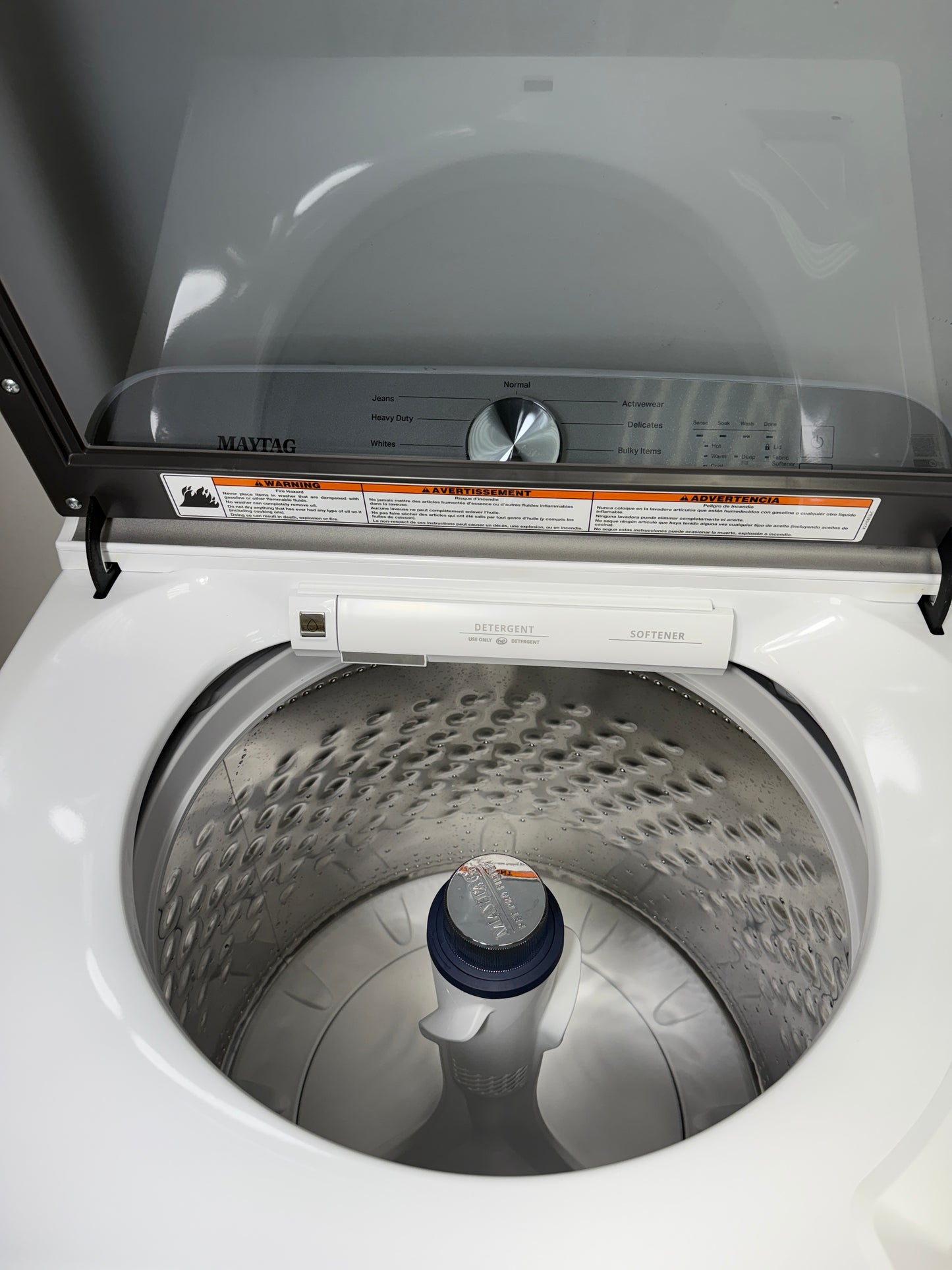 A close-up of the durable stainless steel wash basket and agitator inside the MVW6500MW washer, designed for tough messes. On sale at Appliance Shark - Scratch & Dent store | Kansas City.