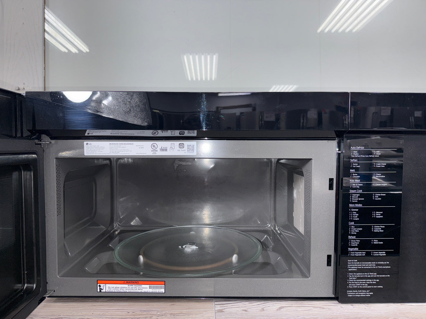 A close-up of the LG MVEL2137F's spacious 2.1 cu. ft. interior, showcasing the easy-clean coating and turntable. A great scratch and dent deal in Overland Park.