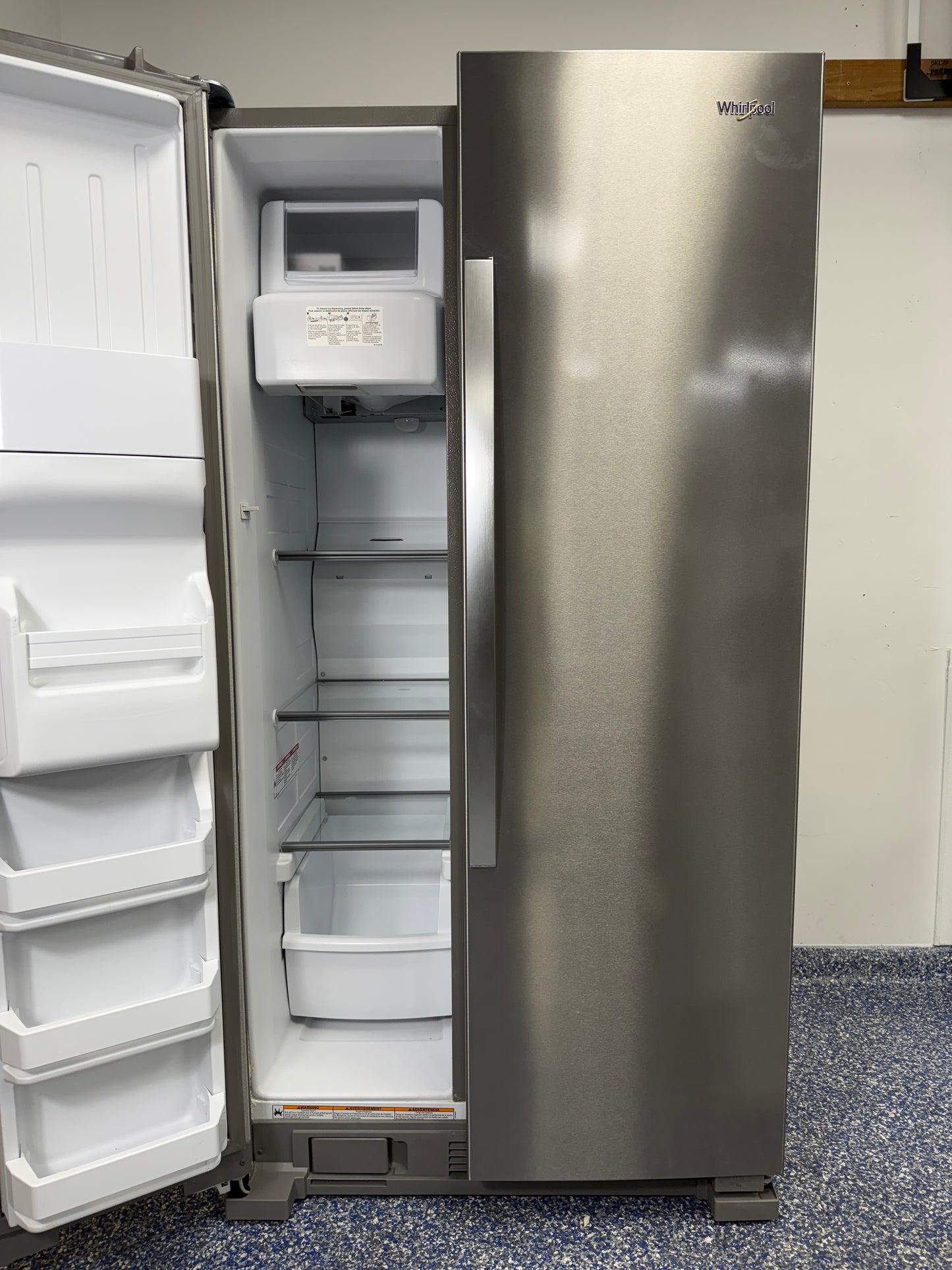 A detailed shot of the WRS325SDHZ freezer compartment, showcasing the efficient LED interior lighting and wire shelving.