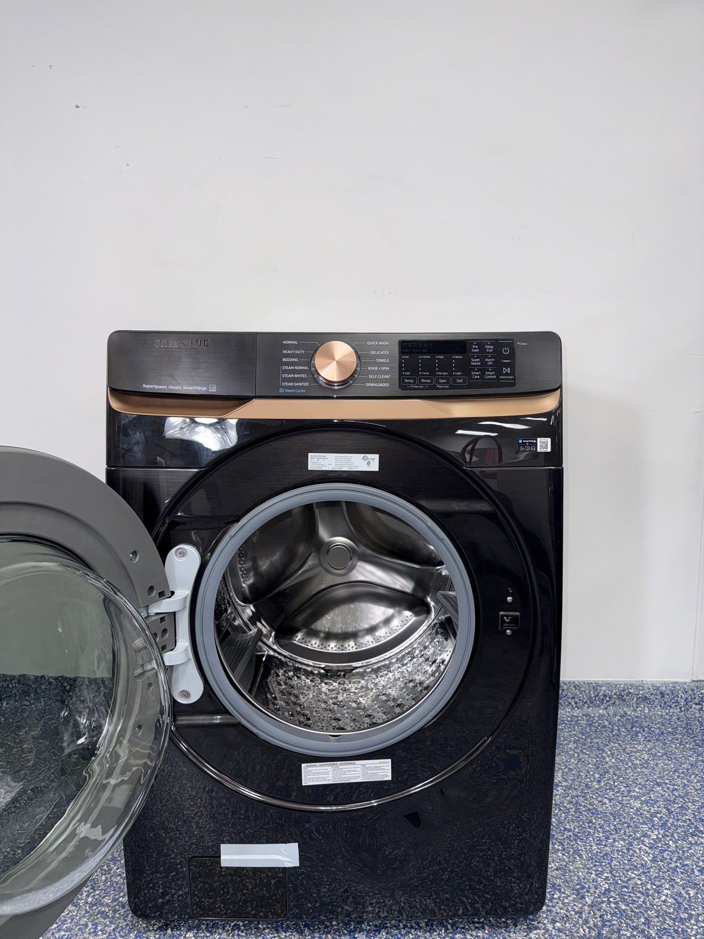 A close-up view of the interior of the SAMSUNG WF50BG8300AVUS washer, showcasing its Self Clean+ feature, an ideal appliance for homes in Overland Park.