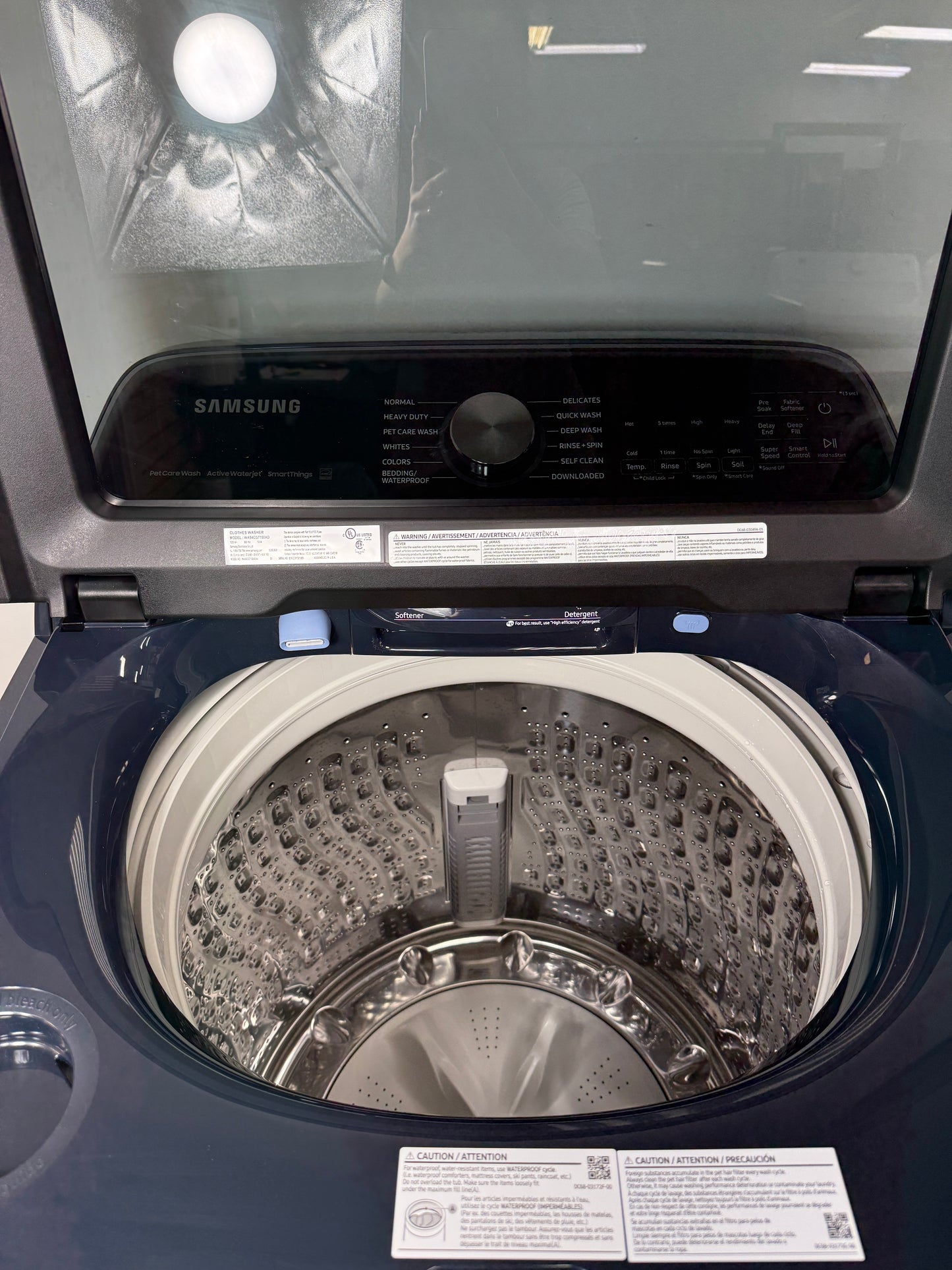 A close-up of the durable stainless steel Swirl+ tub interior of the WA54CG7150AD washer, designed for gentle yet effective cleaning. On sale at Appliance Shark - Scratch & Dent store | Kansas City.