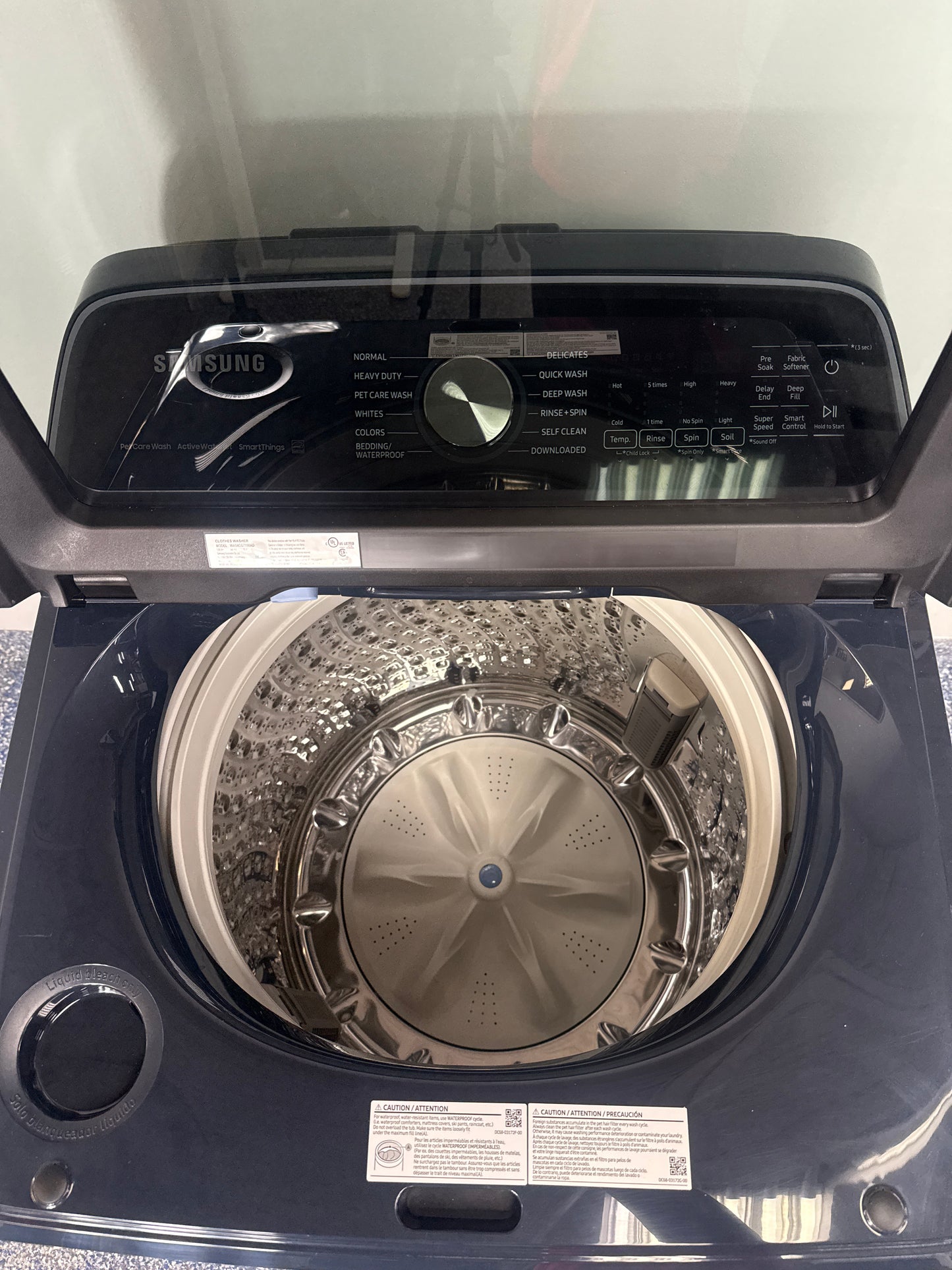 Scratch & dent Samsung WA54CG7150AD washer on display at Appliance Shark in Overland Park, featuring smart features and pet hair solution.