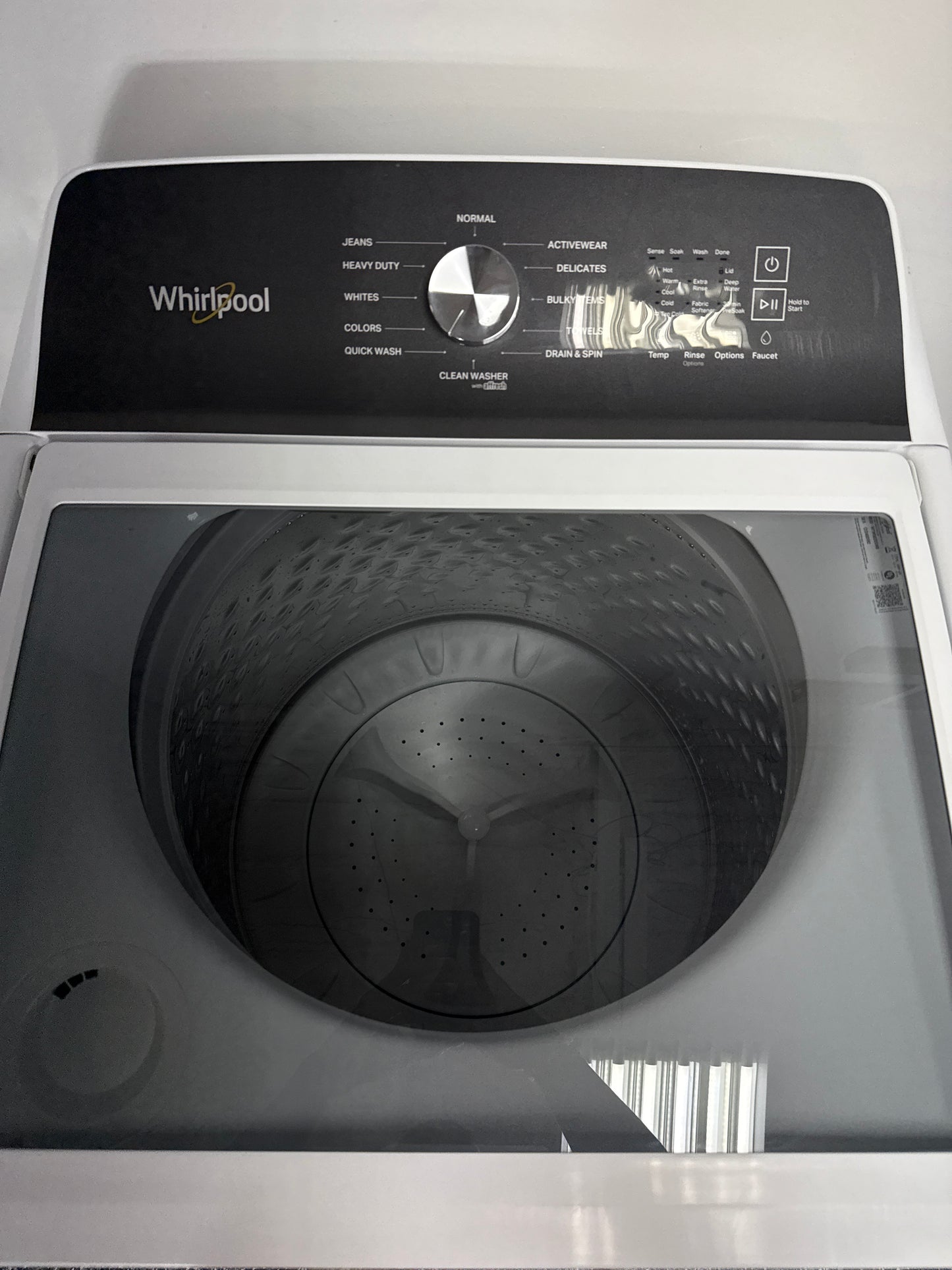 The interior of the WHIRLPOOL WTW5020SW washer, showing the Smooth Impeller and Auto Sensing technology, an ideal appliance for homes in Overland Park.