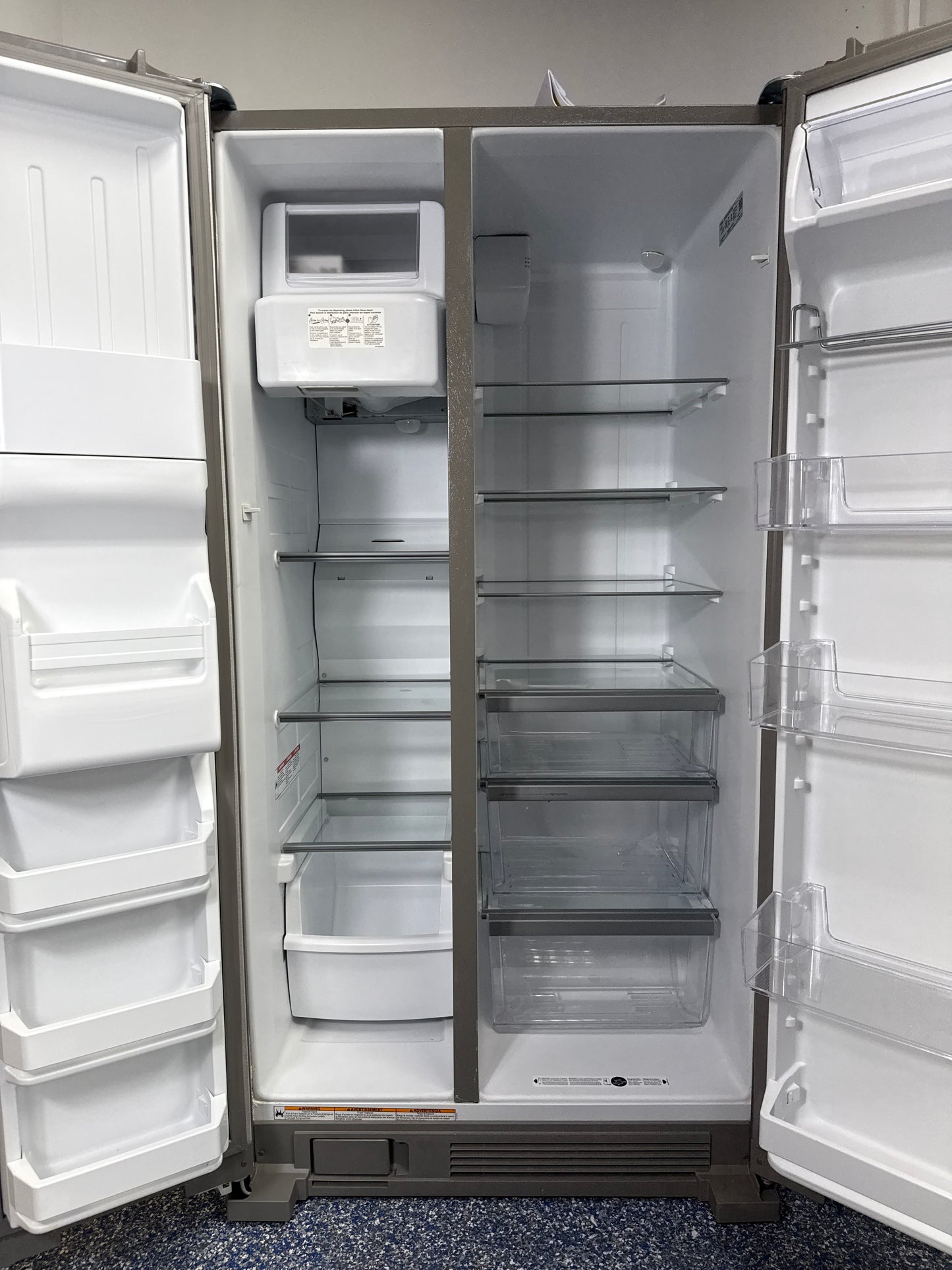 Interior look at the WRS325SDHZ refrigerator, highlighting the spacious In-Door-Ice storage and adjustable gallon door bins.