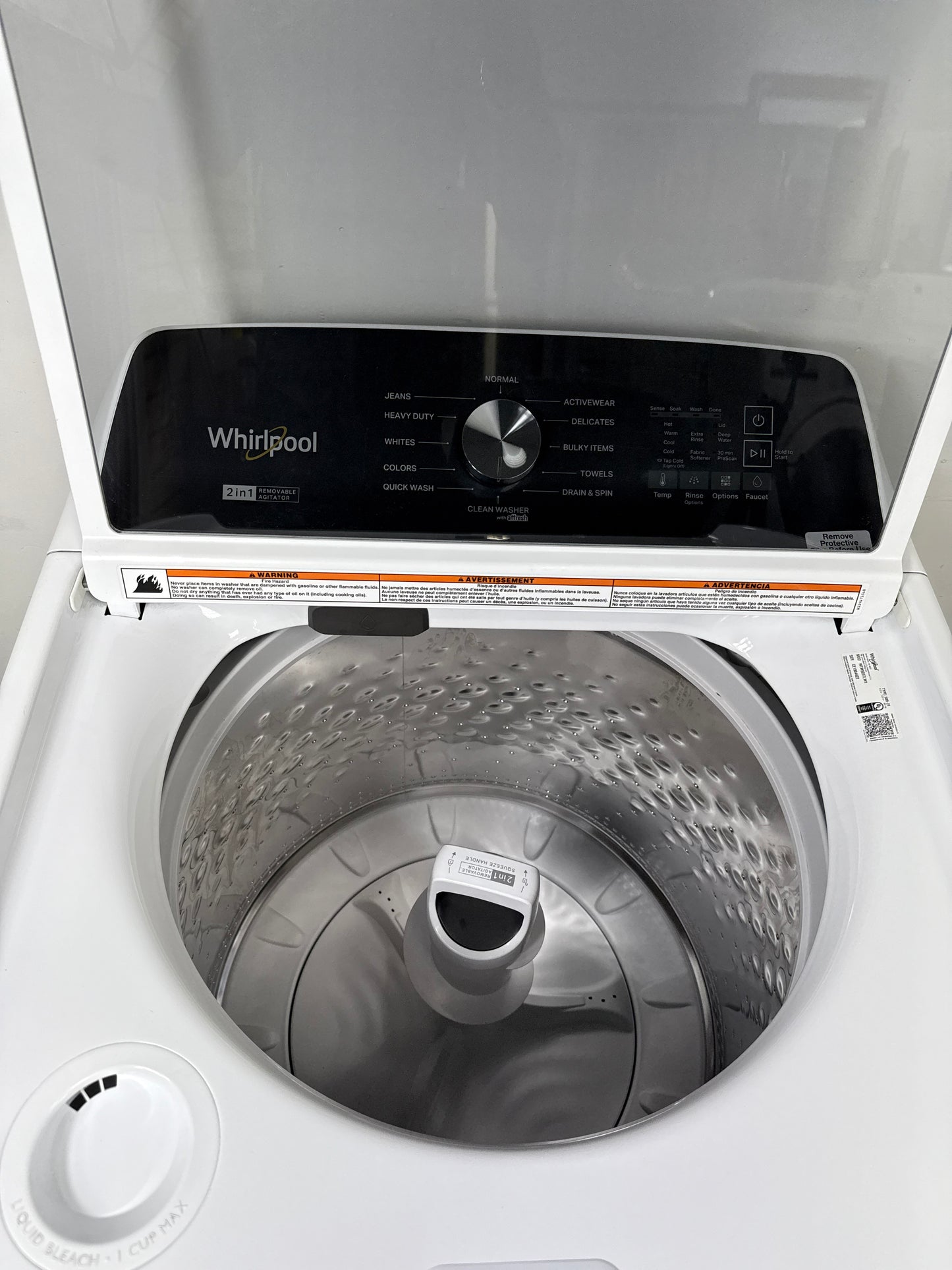 A close-up view of the interior of the WTW5057LW washer, highlighting the durable porcelain tub and built-in Pretreat Station. This scratch & dent deal is available in Kansas City.