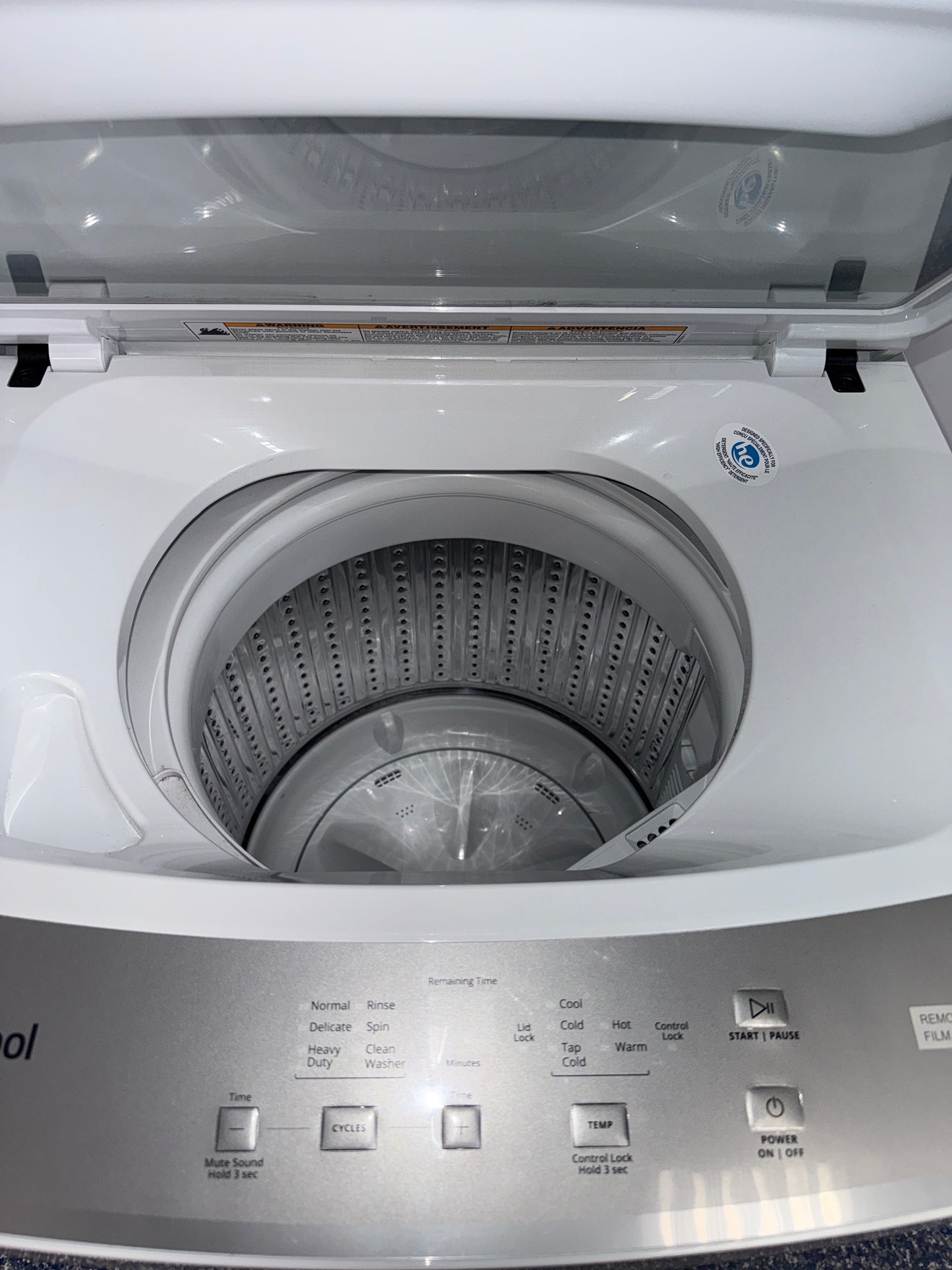 The interior of the WHIRLPOOL WET4024HW washer, showcasing the Smooth Wave Stainless Steel Wash Basket, for sale in Kansas.