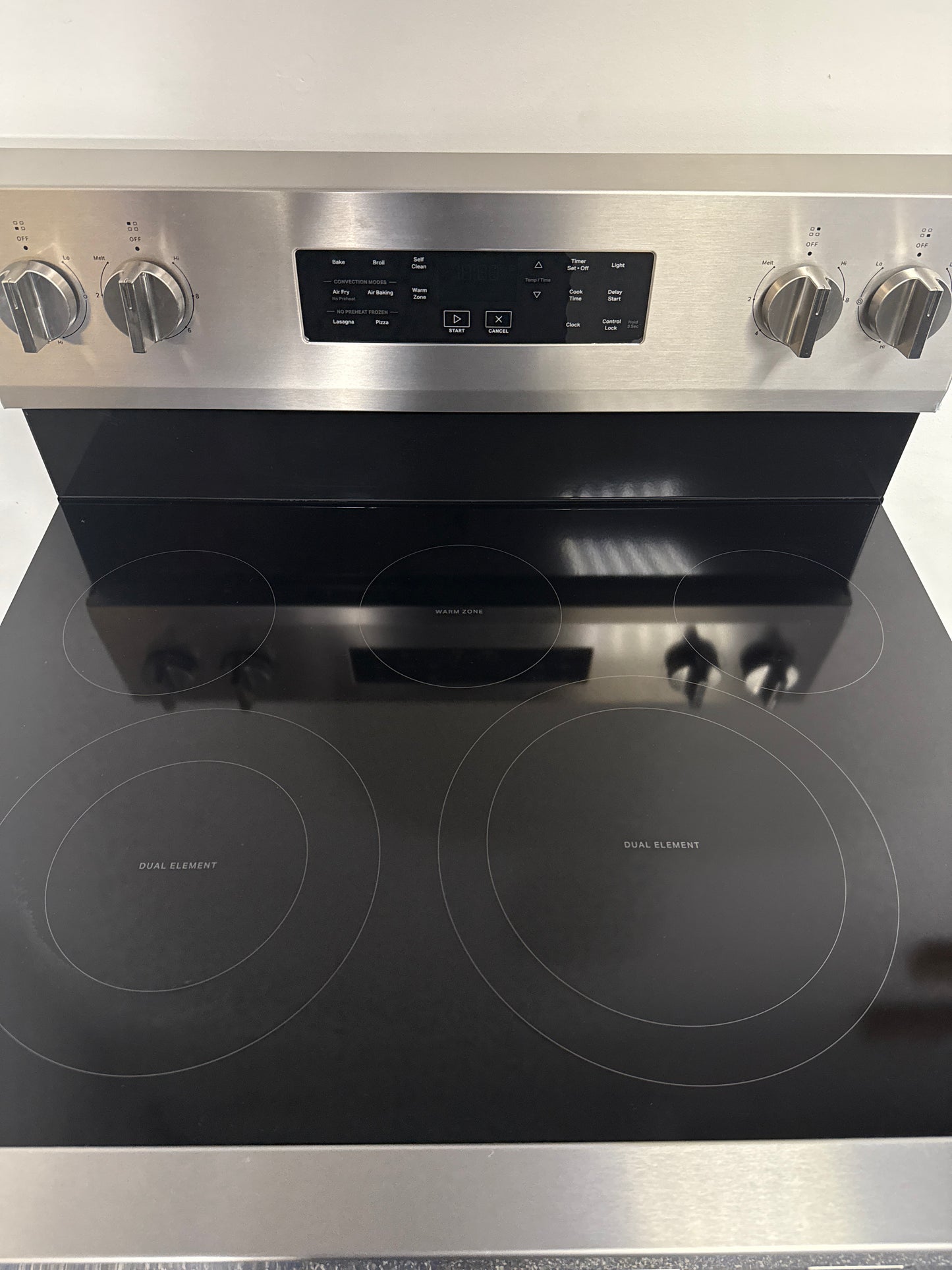 A front view of the WHIRLPOOL WFES5030RZ range, highlighting its Keep Warm Setting, ready for installation in a Kansas City kitchen.