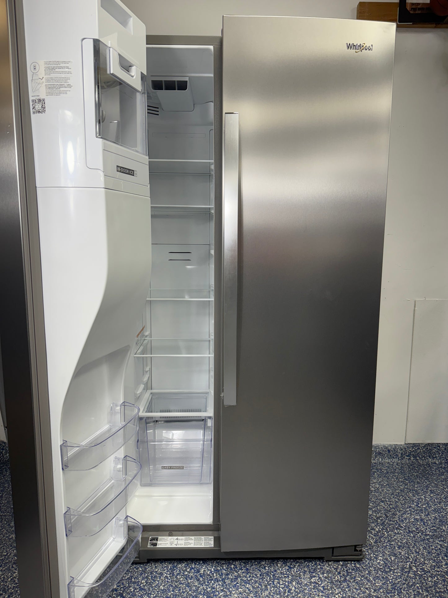 An overhead shot of the WHIRLPOOL WRSC5536RZ with both doors open, showcasing the interior shelves, bins, and In-Door-Ice storage. On sale at Appliance Shark - Scratch & Dent store | Kansas City.