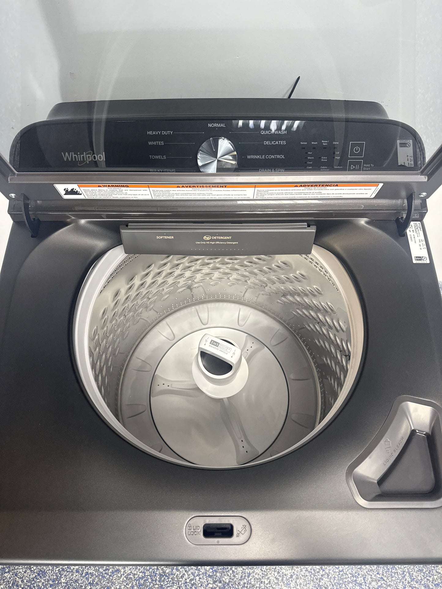 Interior view showing the smooth spiral stainless steel wash basket of the WHIRLPOOL WTW6157PB1 washer in a Kansas City home.