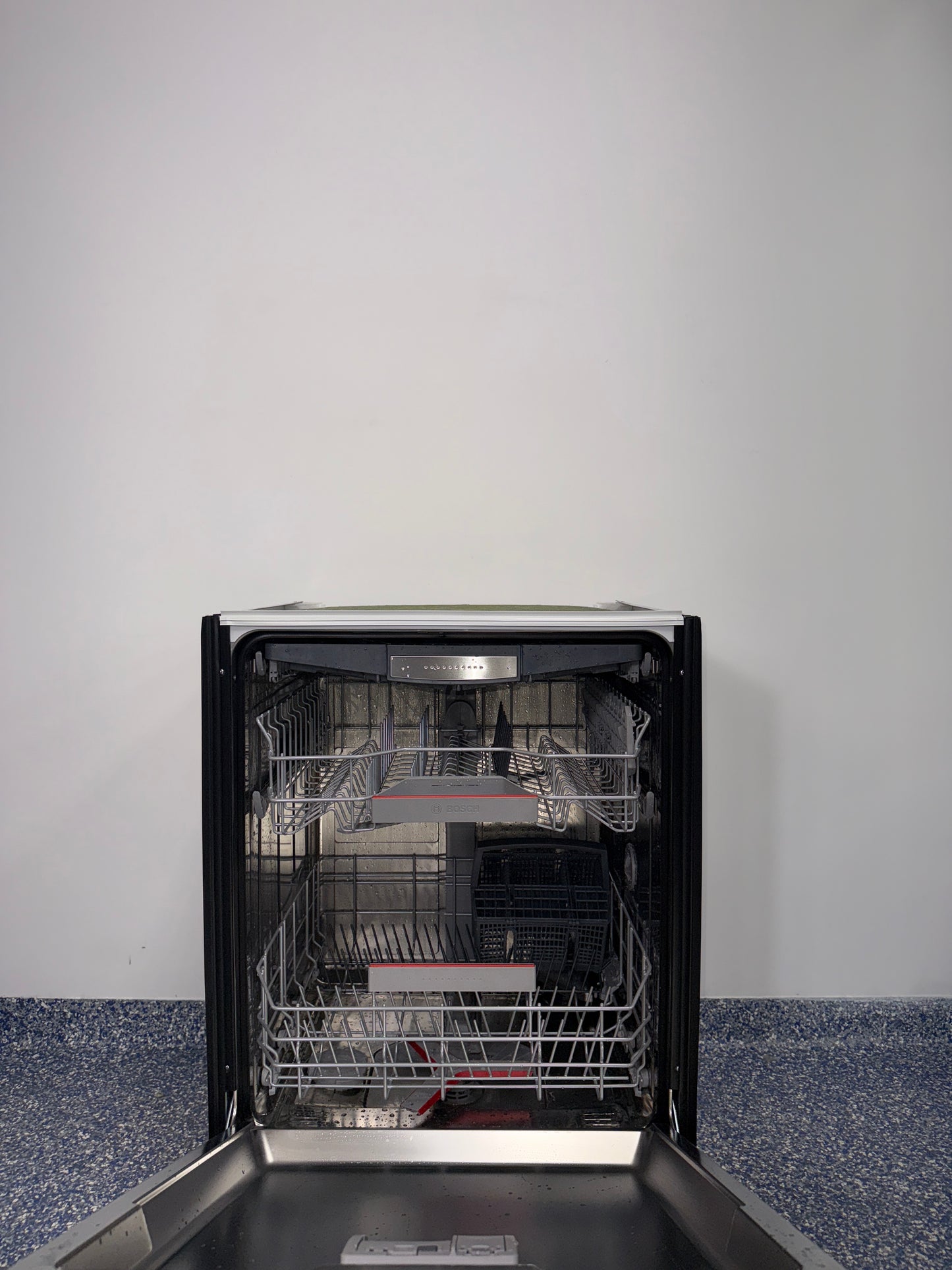 Interior of BOSCH SHX78CC5UC dishwasher with 3rd rack flexibility, discounted at Appliance Shark in Kansas City.