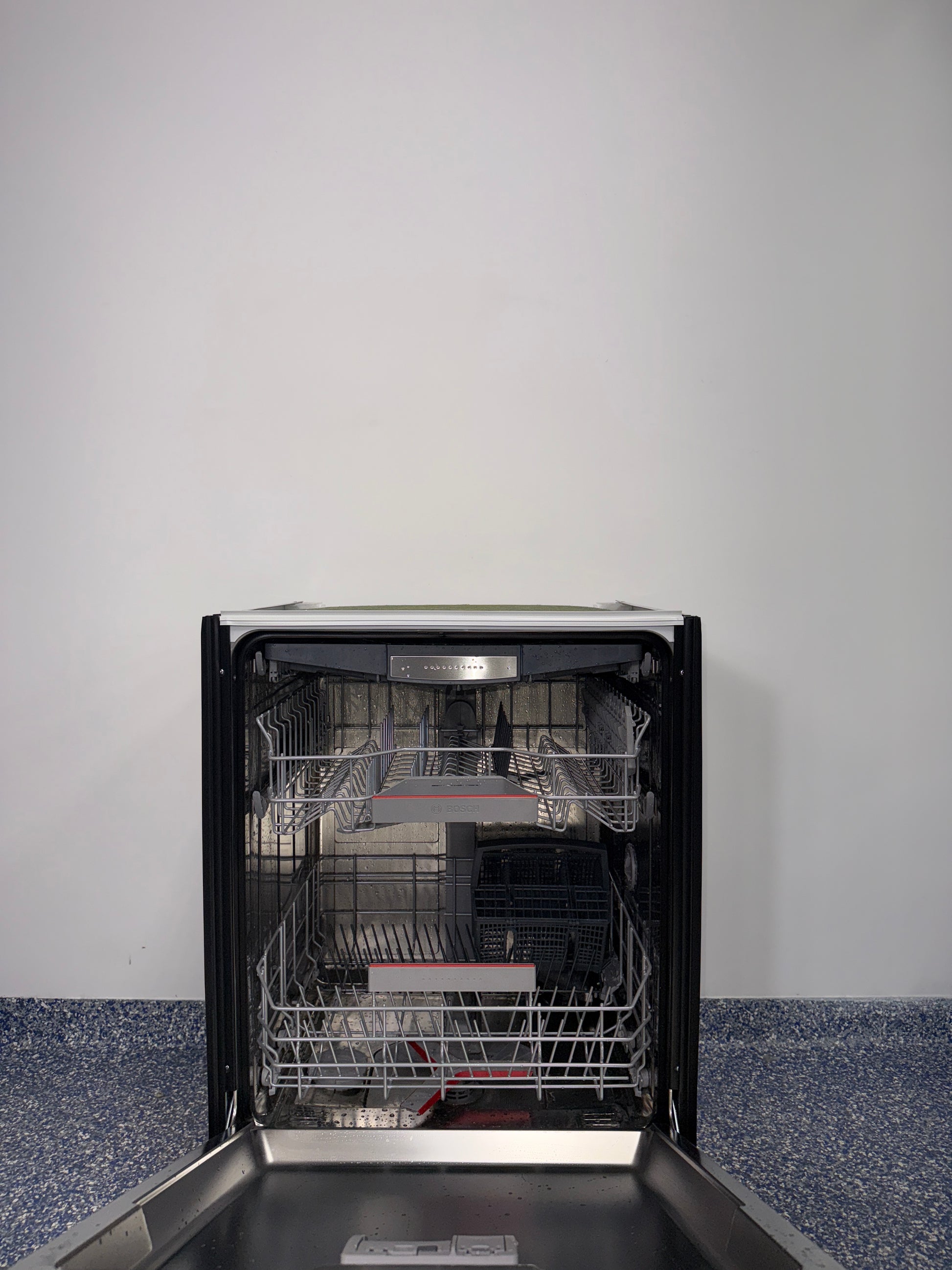 Interior of BOSCH SHX78CC5UC dishwasher with 3rd rack flexibility, discounted at Appliance Shark in Kansas City.