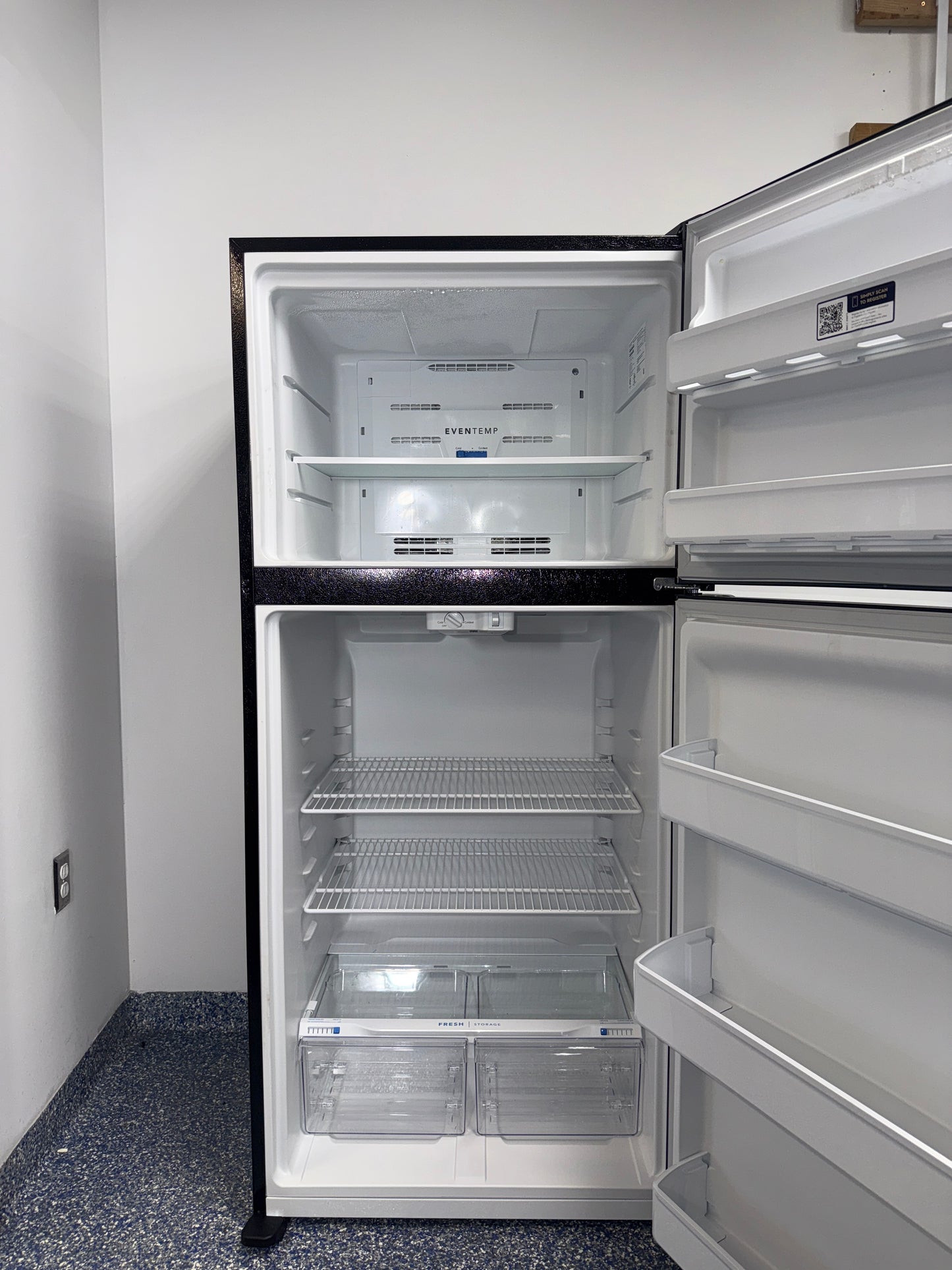 The interior of the FRIGIDAIRE FFTR1814WB refrigerator, showcasing its adjustable shelves, an ideal appliance for homes in Overland Park.