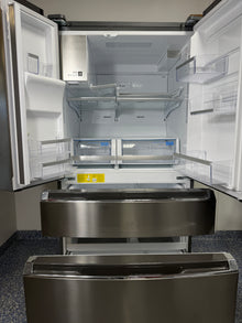 A close-up of the interior of the GRMC2273CF refrigerator, highlighting the CrispSeal® Plus crispers and SpaceWise® Adjustable Shelving System. On sale at Appliance Shark - Scratch & Dent store | Kansas City.