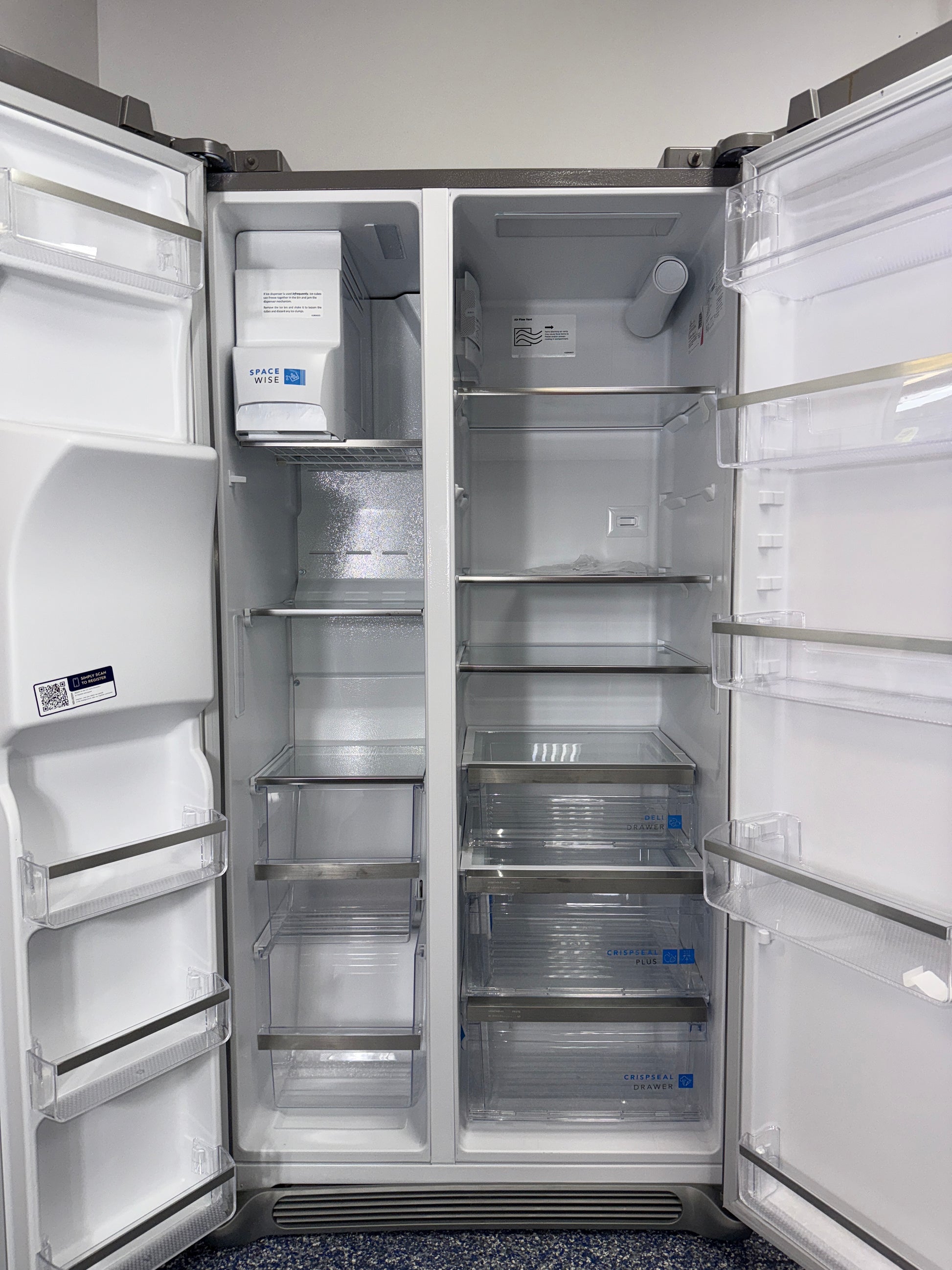 A close-up view of the filtered water and ice dispenser on the FRIGIDAIRE GRSC2352AF, for sale in Kansas.
