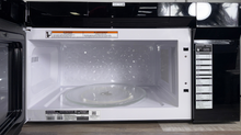 Scratch & dent FRIGIDAIRE Gallery GMOS1964AF microwave displayed at Appliance Shark in Overland Park with smudge-proof stainless steel design.