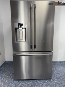 A full frontal image of the FRIGIDAIRE PRFS2883AF French door refrigerator, highlighting its Smudge-Proof® Stainless Steel finish and external dispenser. On sale at Appliance Shark - Scratch & Dent store | Kansas City.
