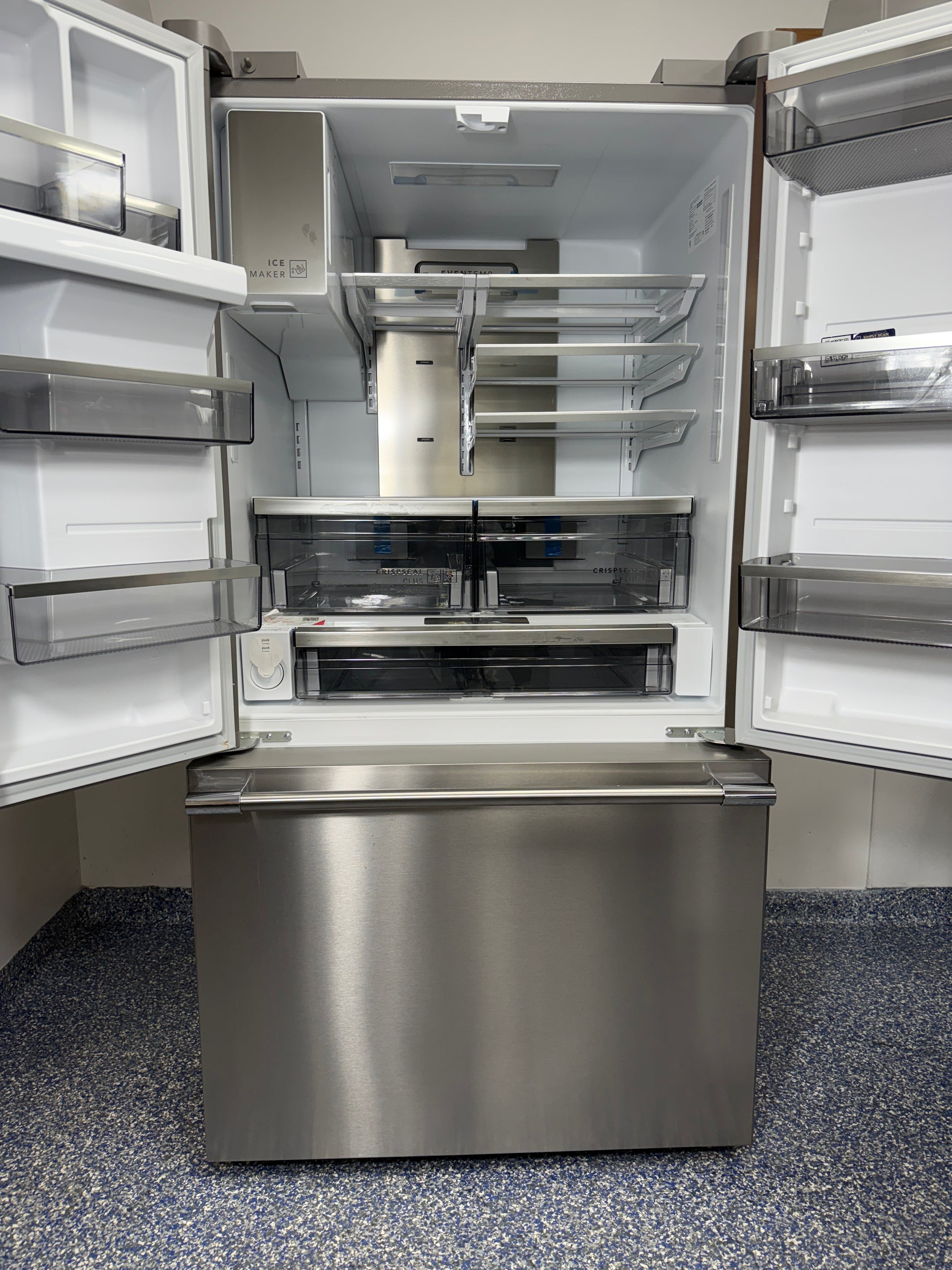 A view inside the main refrigerator compartment of the FRIGIDAIRE PRFS2883AF, highlighting the glass shelves, CrispSeal® Plus crispers, and adjustable temperature drawer. On sale at Appliance Shark - Scratch & Dent store | Kansas City.