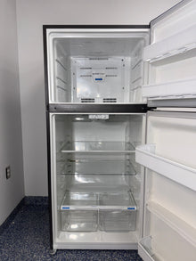 The FRIGIDAIRE top-freezer refrigerator, model LFTR1835VF, with its adjustable glass shelves, available at Appliance Shark.

