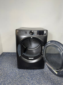 An overhead shot of the GE GFD65ESPVDS with the door open, revealing the spacious stainless steel drum. On sale at Appliance Shark - Scratch & Dent store | Kansas City.