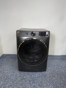 A full frontal image of the GE Profile GFD65ESPVDS front-load smart electric dryer, highlighting its Carbon Graphite finish. On sale at Appliance Shark - Scratch & Dent store | Kansas City.