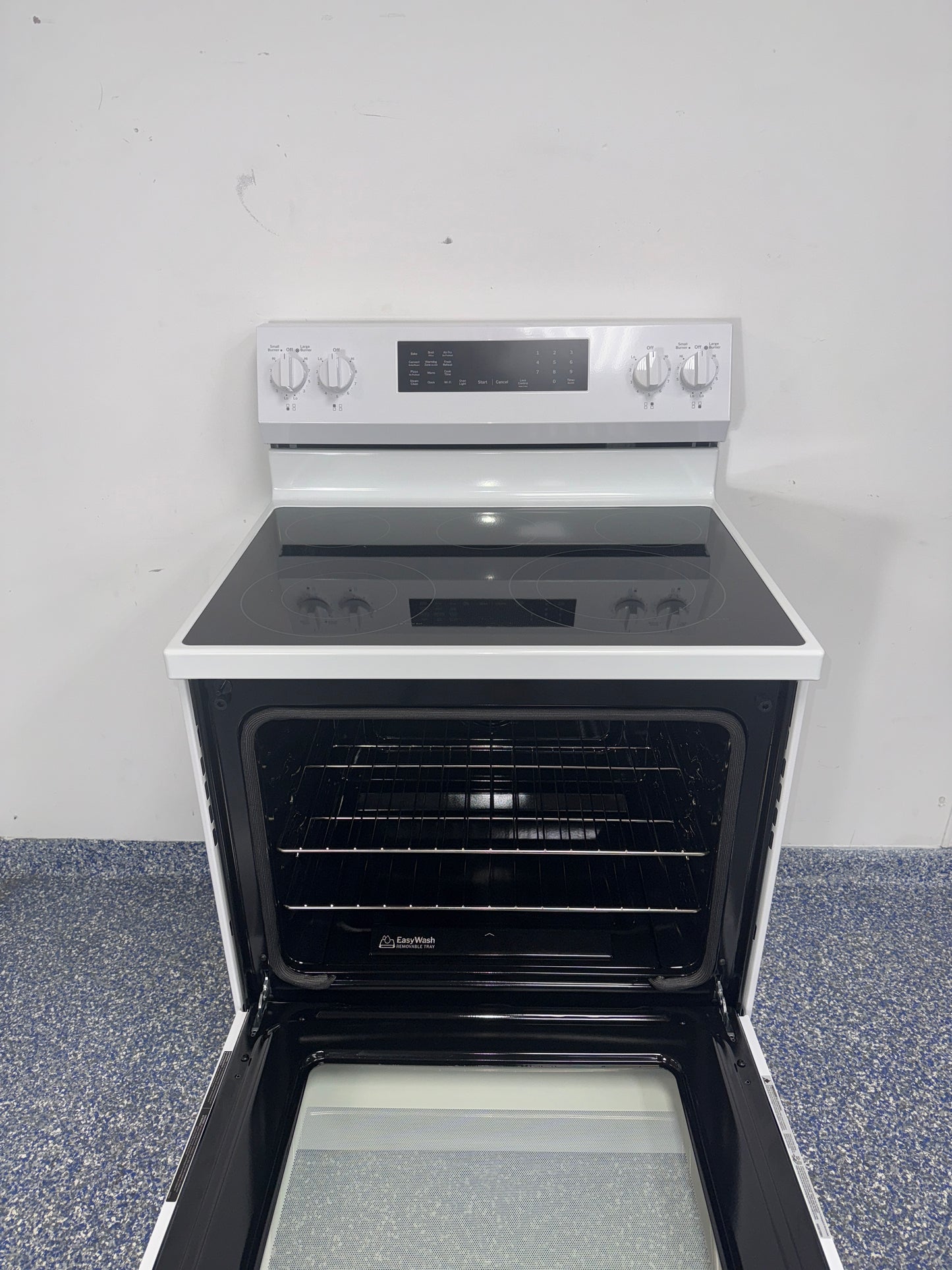 GE GRF600AV2WW electric range smooth cooktop view in Overland Park KS